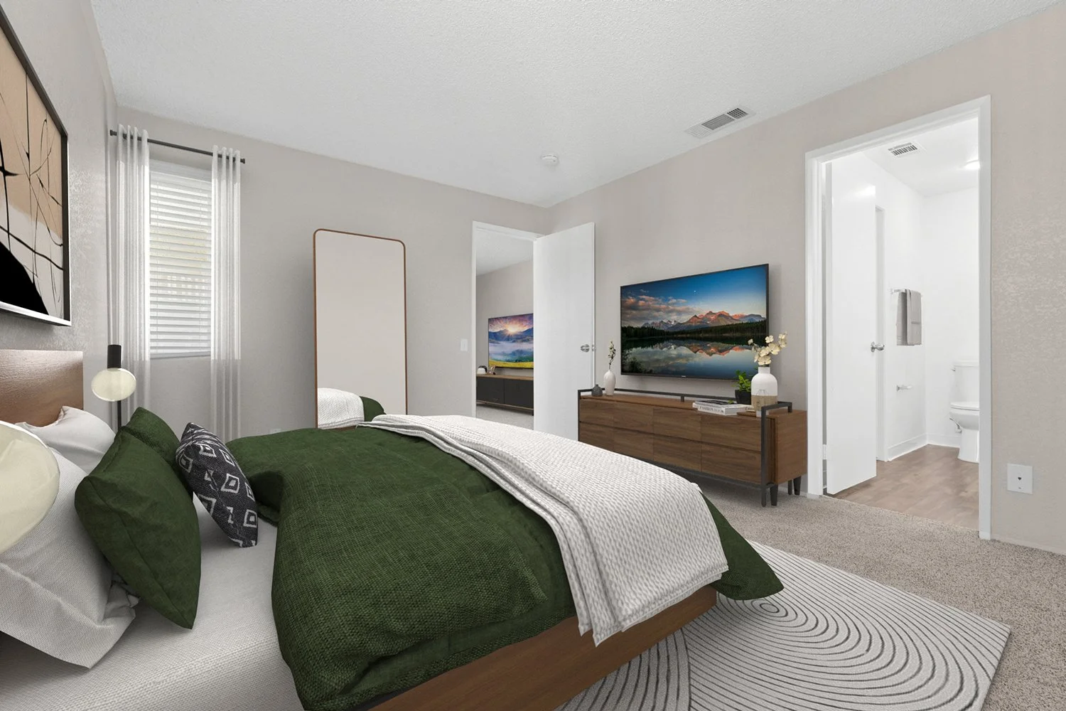 Spacious primary bedroom in Andorra 2 bedroom apartment home with plush carpeted flooring, private bathroom, and large windows allowing for gorgeous natural lighting. 