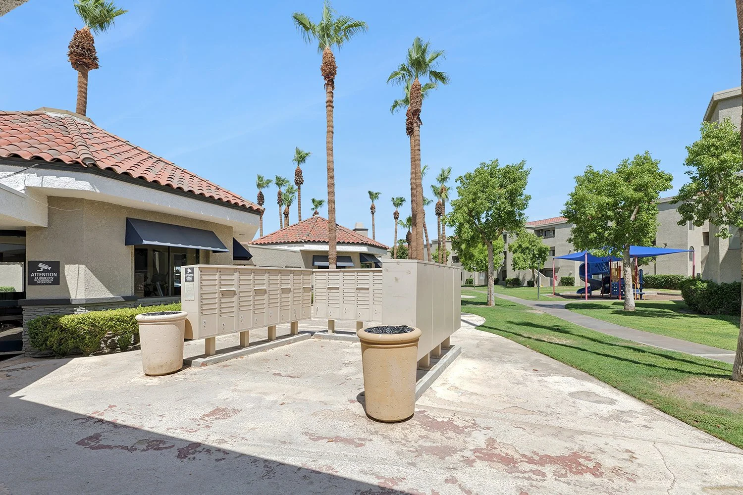 This image shows the community's outdoor mail area featuring several metal mailboxes next to the leasing office.