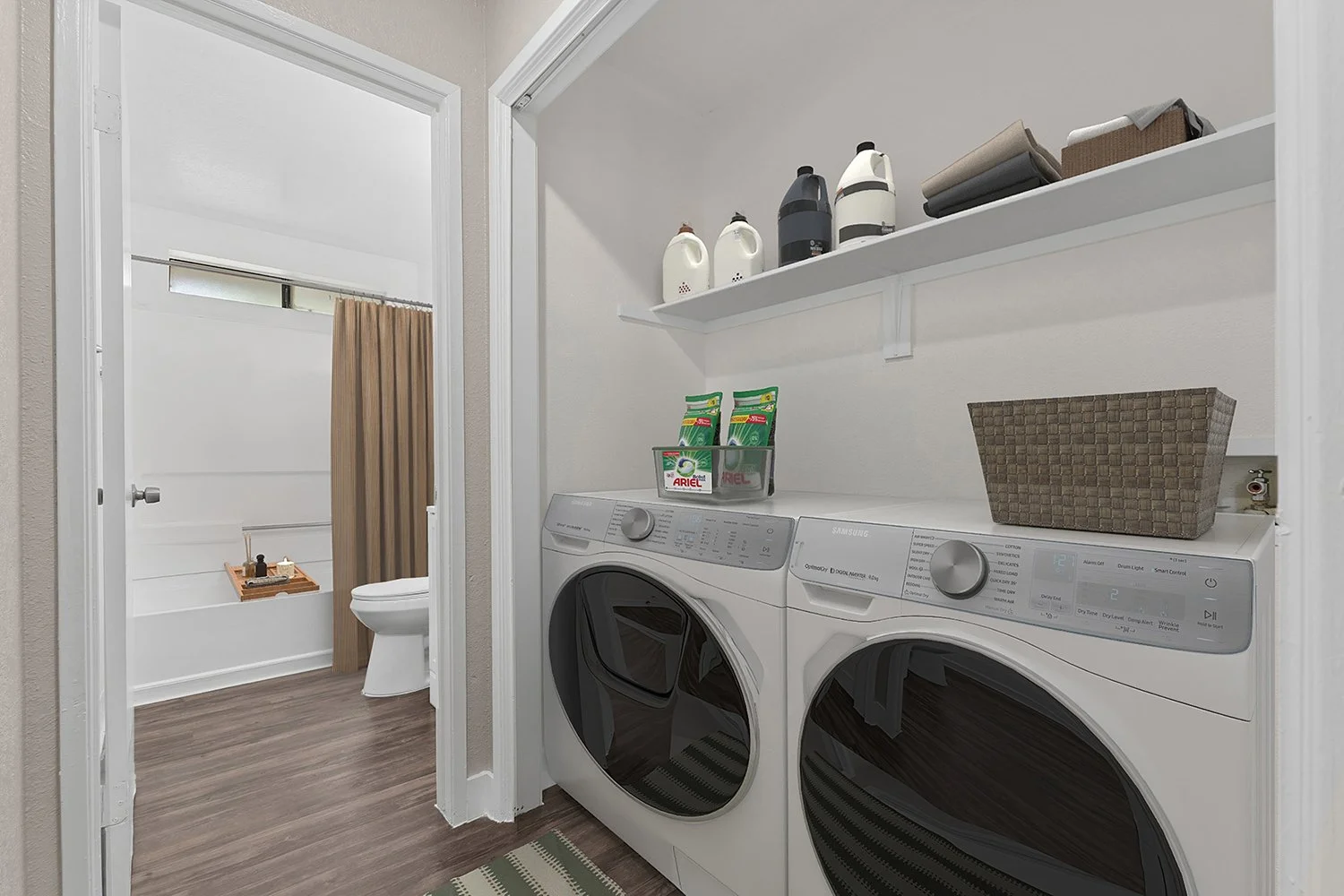 Full-sized in-unit washer and dryer in Andorra 2 Bedroom apartment home, tucked away in wall inlet in the hallway leading to the bathroom. 