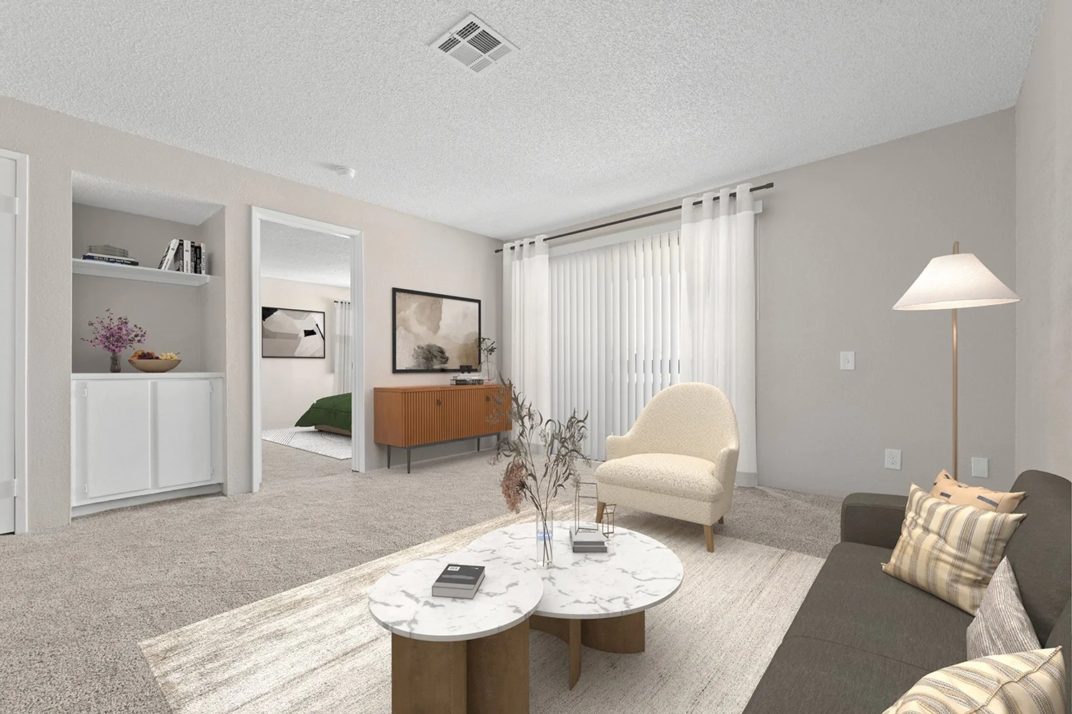 Spacious living area in Andorra 2 bedroom apartment home with plush carpeted flooring and sliding doors leading to private patio. 