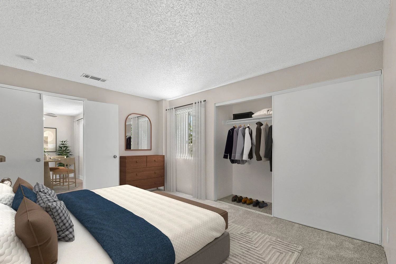 Second bedroom in Andorra 2 bedroom apartment home with plush carpeted flooring, oversized closet, and large windows allowing for gorgeous natural lighting. 