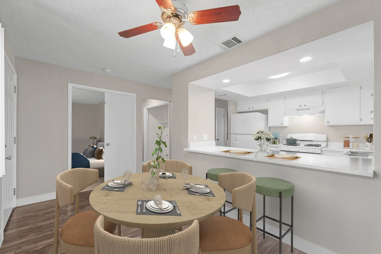 Dining nook in Andorra 2 Bedroom apartment home with wood-style plank flooring, large window, area for stools at the countertop and overhead ceiling fan. 