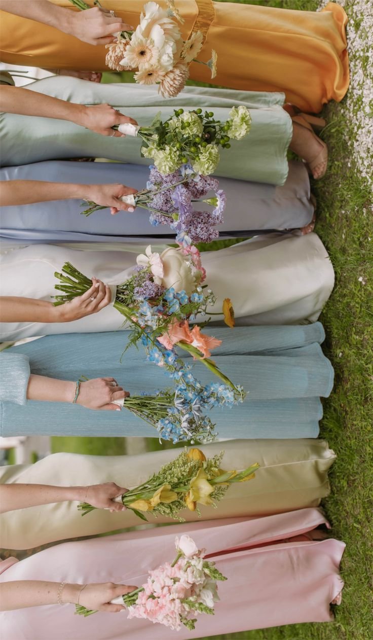 Bride and bridesmaids in pastel wedding dresses with spring flower wedding bouquet. Vaughan wedding Flowers