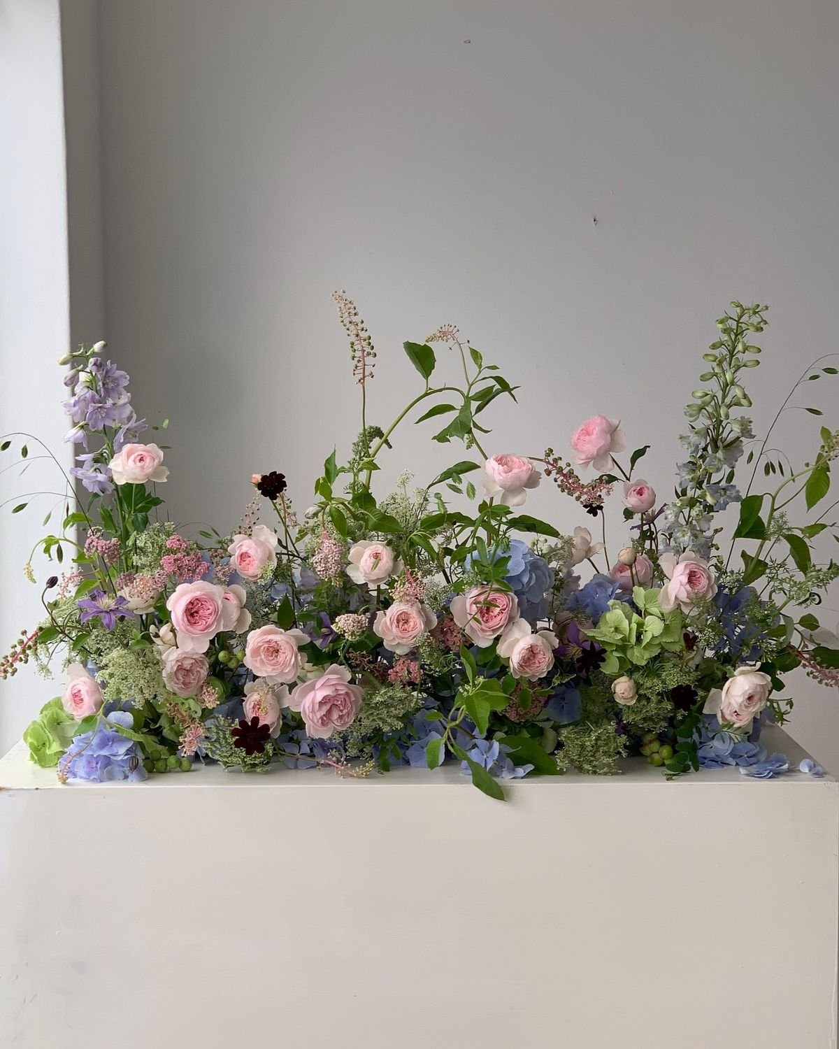 Floral arrangement of pink and lavender flowers with wild garden greenery. Vaughan wedding flowers