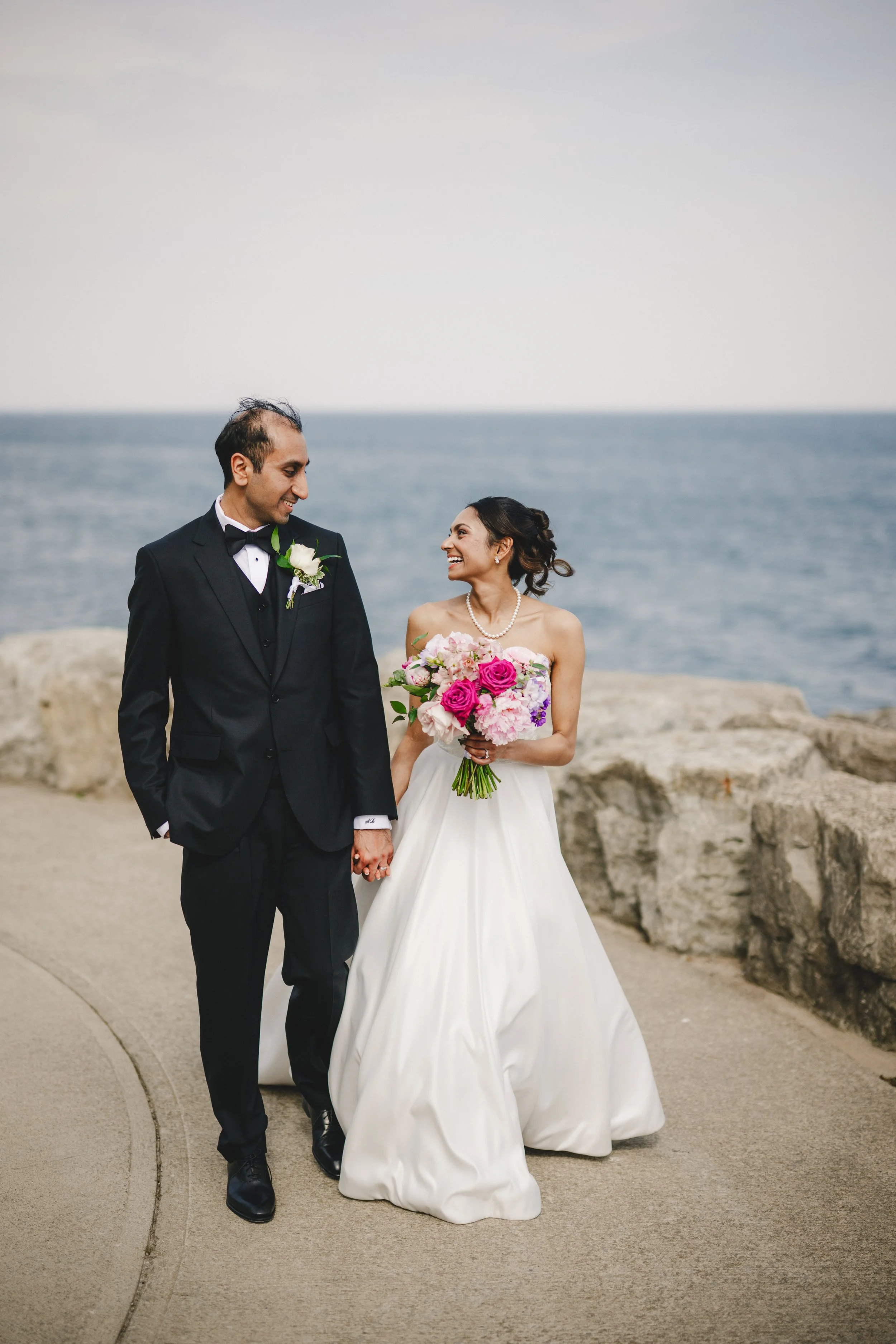 A couple getting having their wedding at the Pearle Hotel and Spa with Pink and Purple Flowers