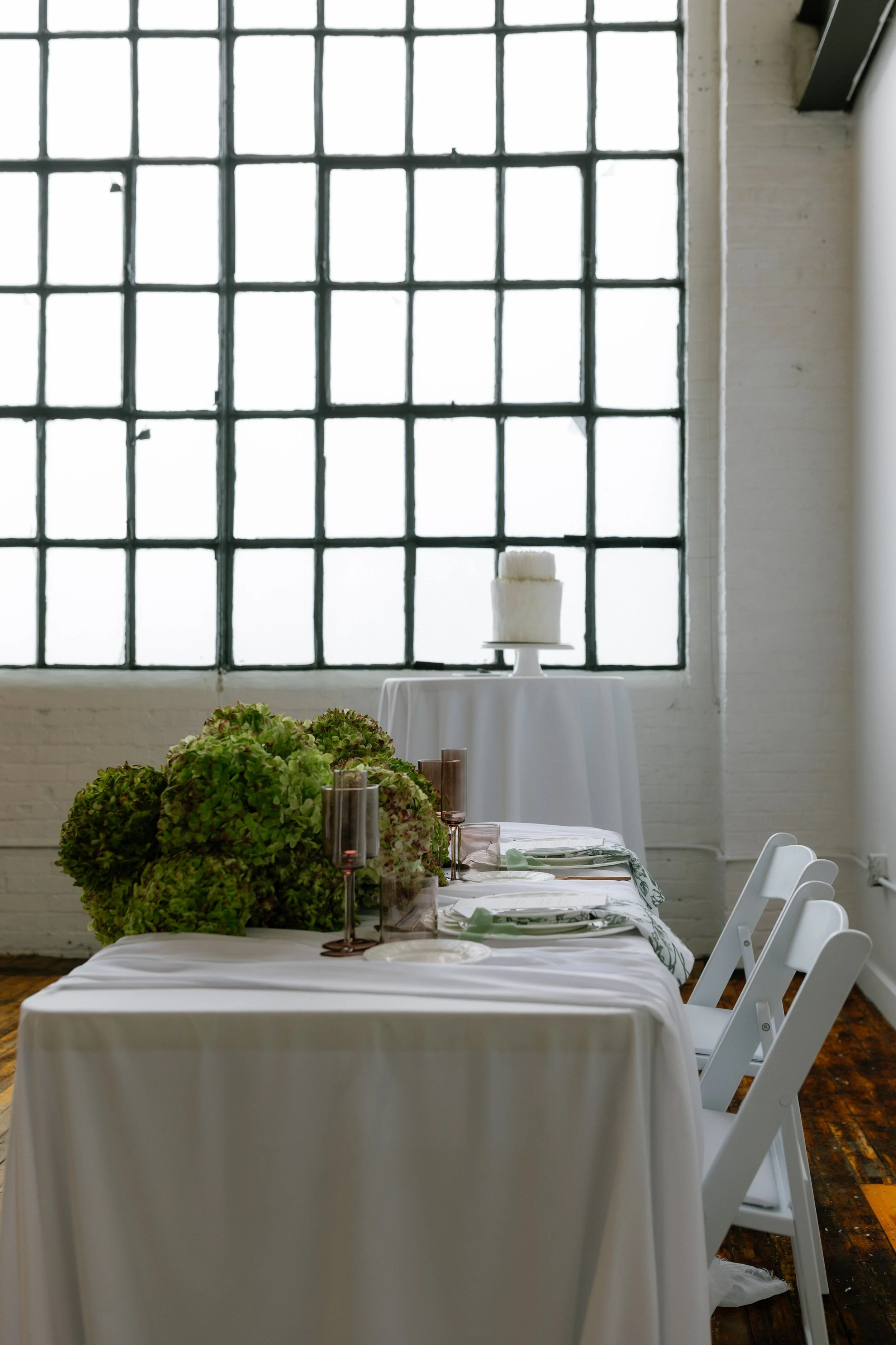 A sweetheart table with lush modern hydrangea arrangement. Toronto Wedding Florist