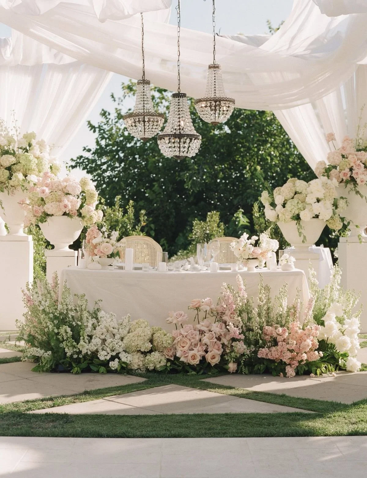 A large sweetheart table at a vaughan wedding surrounded by lush white and blush flowers