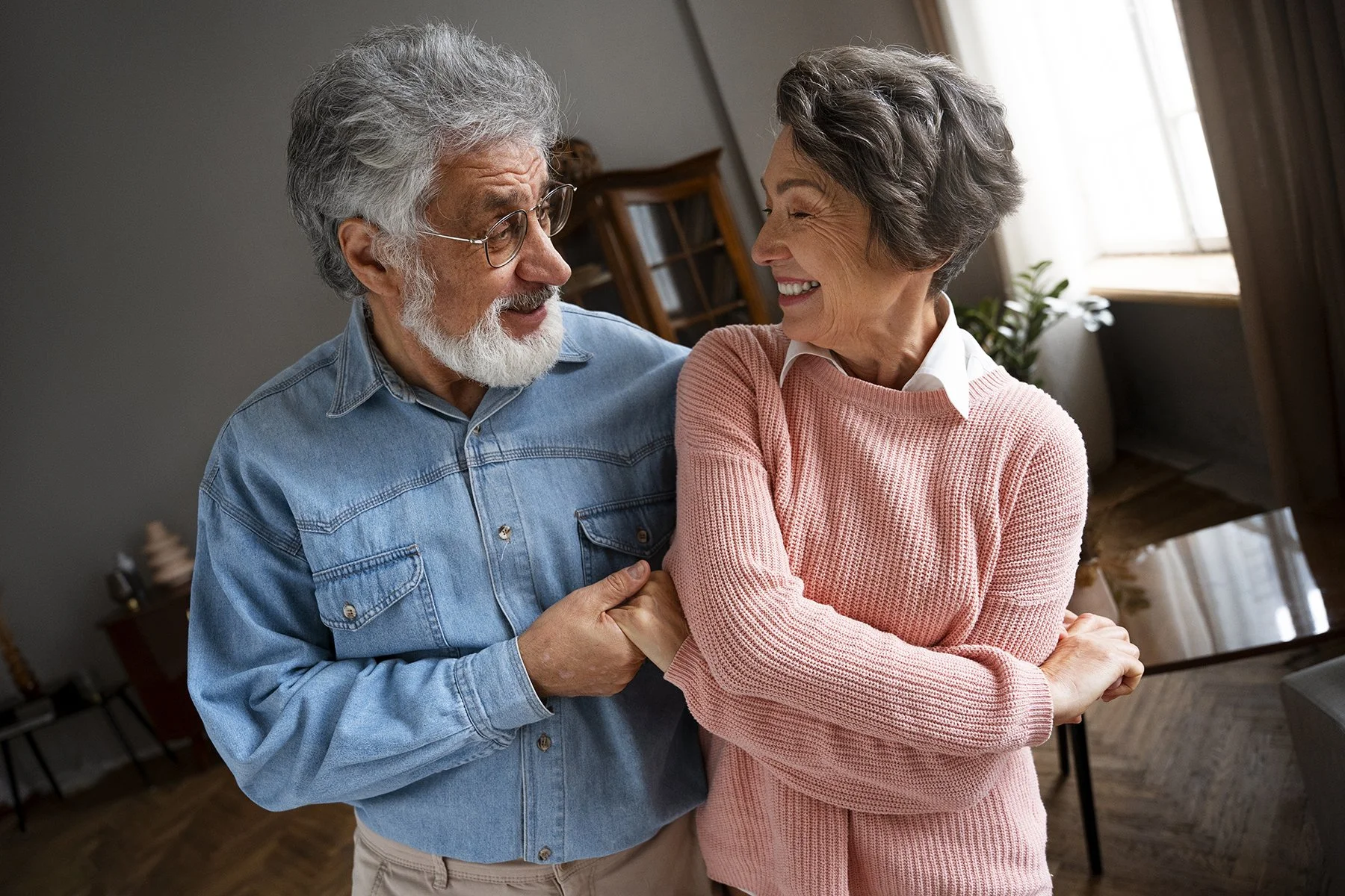 front-view-smiley-senior-couple-indoors.jpg