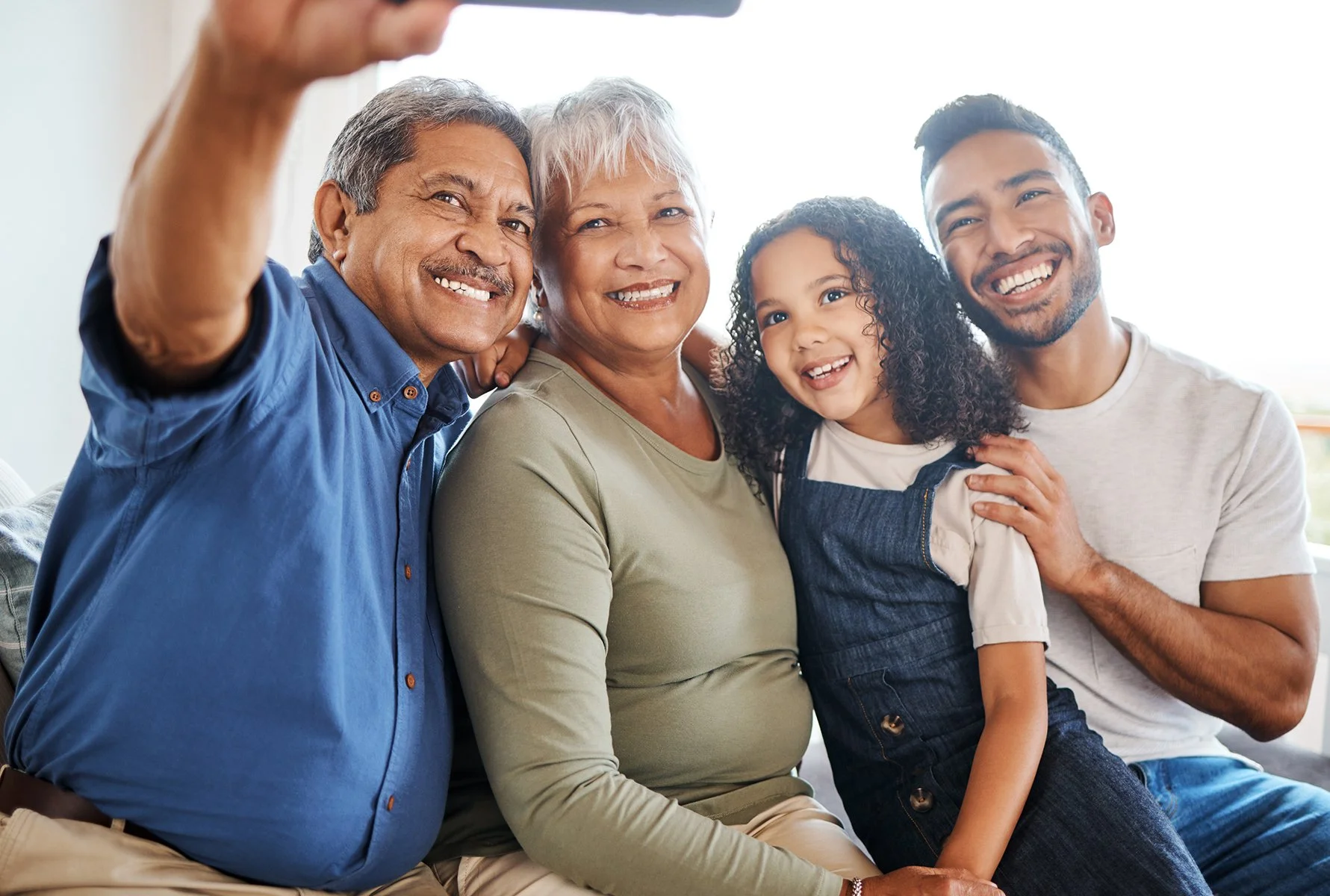 happy-family-smile-selfie-living-room-social-media-vlog-online-post-home-grandparents-father-child-smiling-photo-memory-profile-picture-together-holiday-weekend.jpg