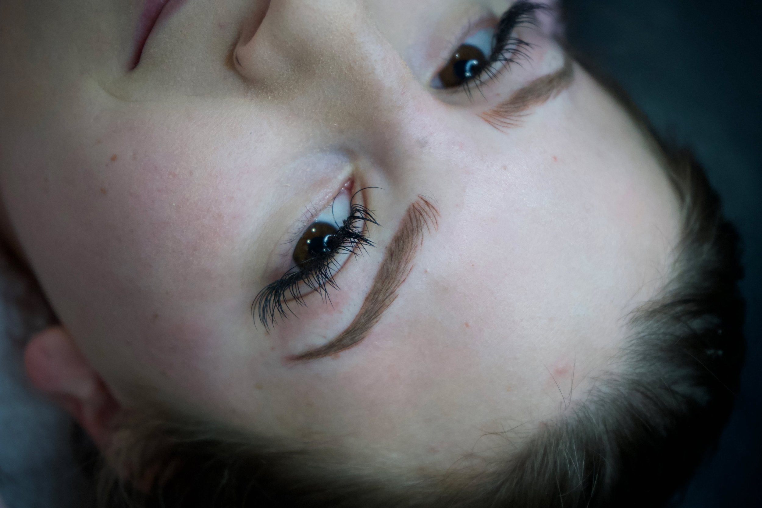 Close-up of a client’s natural-looking permanent makeup brows.