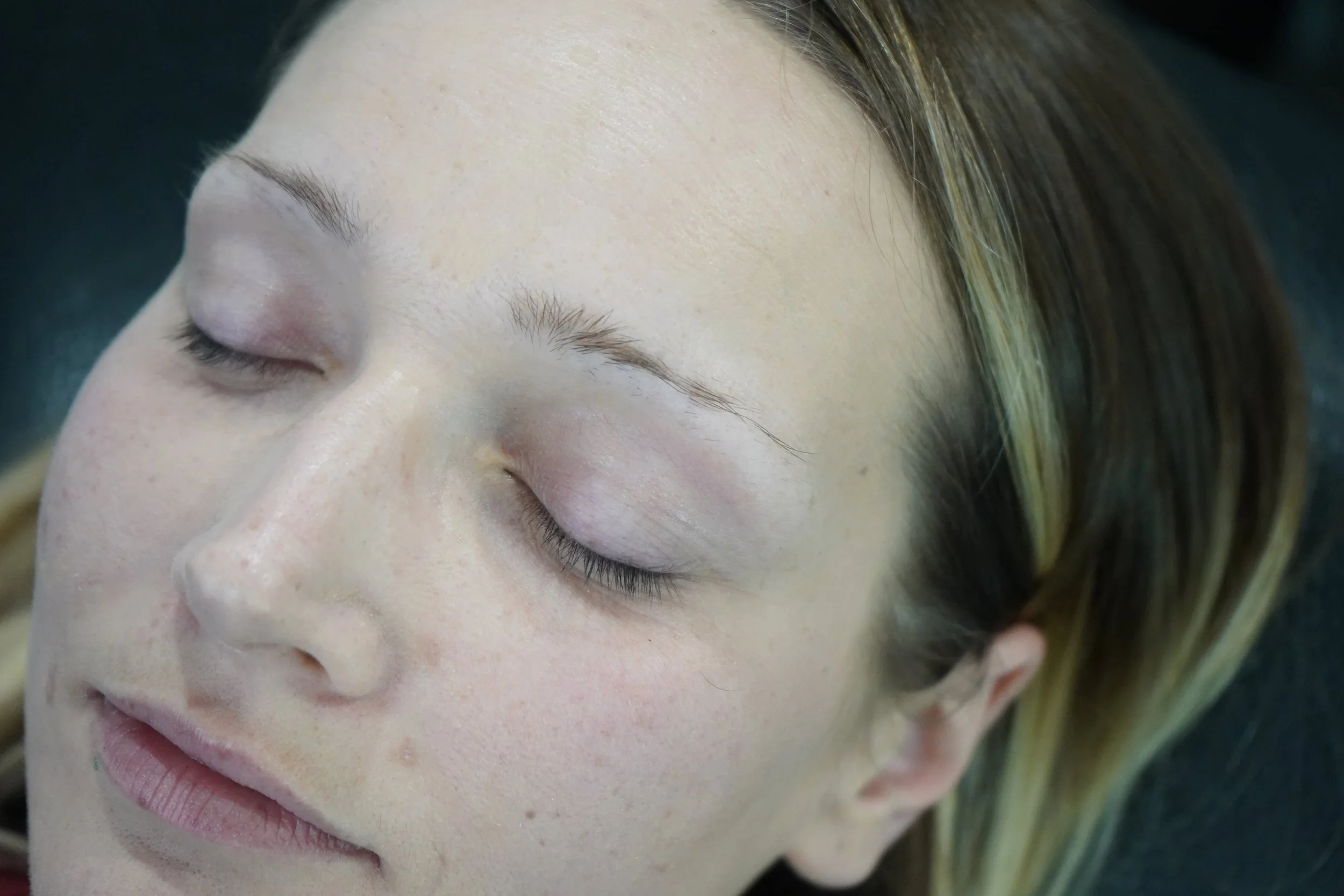 Client with light natural brows before a brow service.