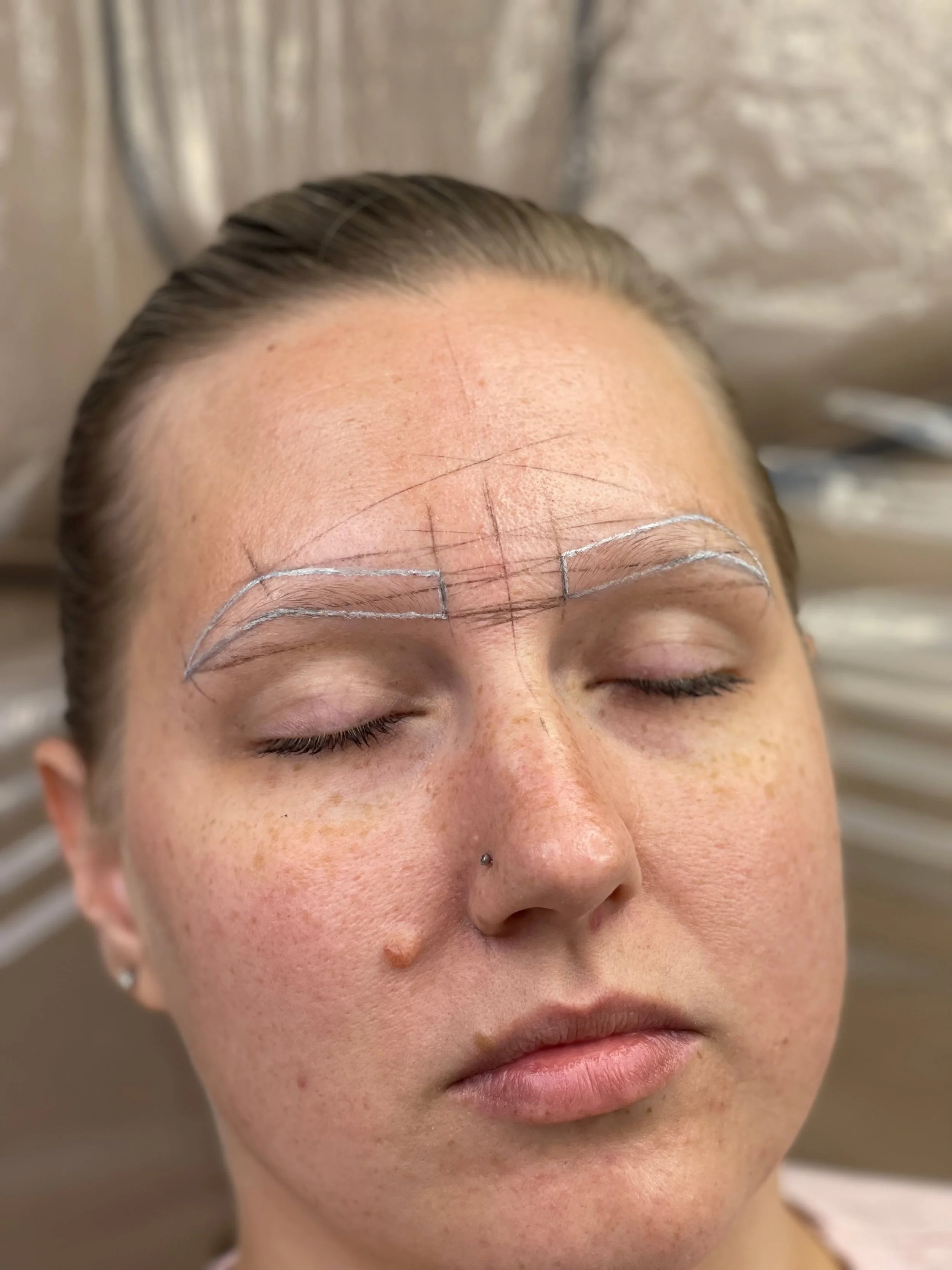 Brow mapping and outline before a permanent makeup treatment.