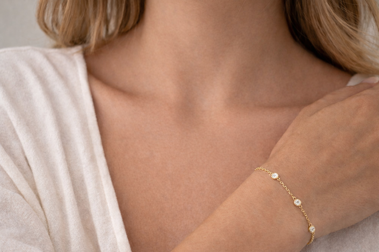 A closeup image of a gold diamond station bracelet from Brilliant Fine+Custom Jewelry
