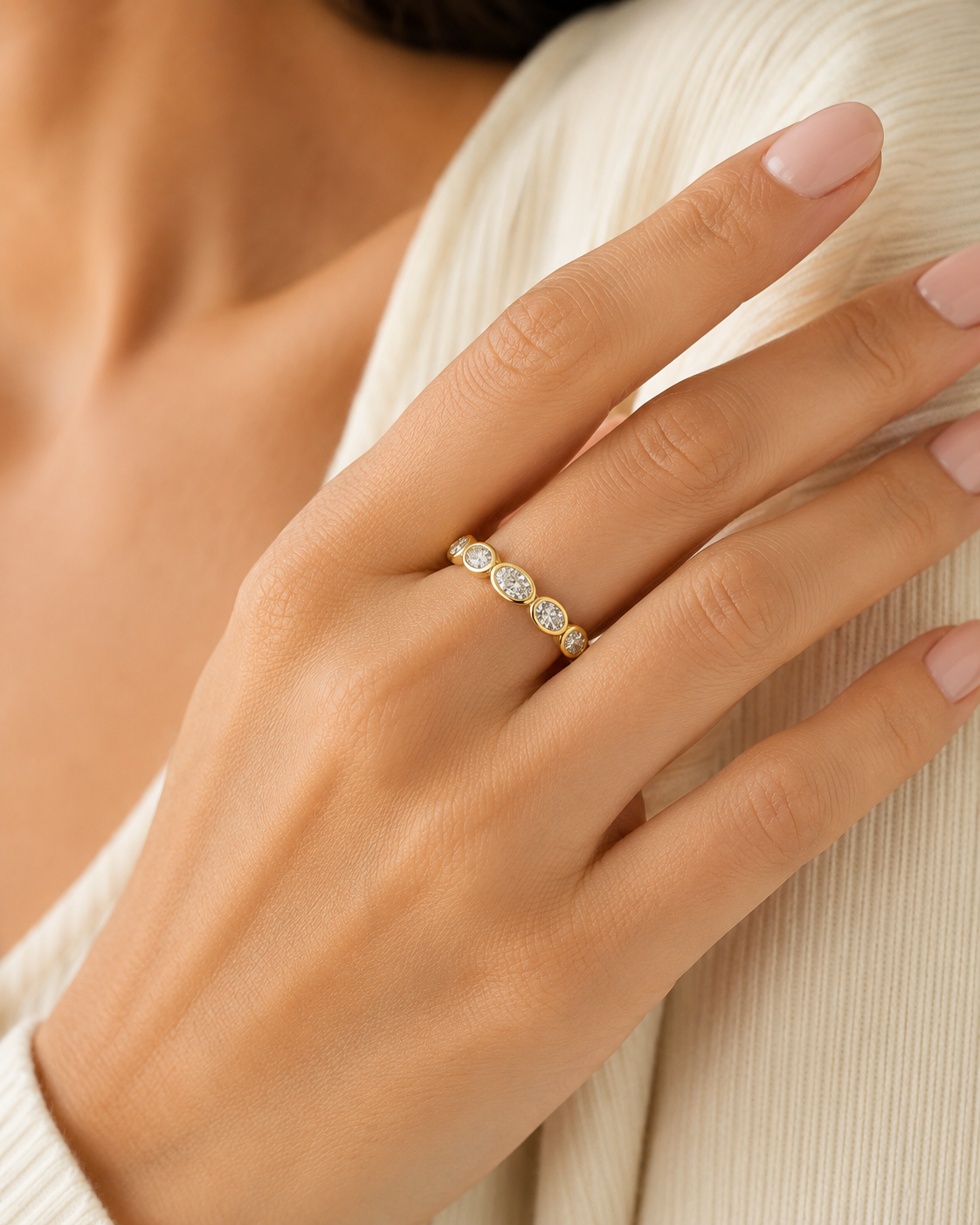 A five-stone bezel set oval band in 14k yellow gold from Brilliant Fine+Custom. A perfect band for a ring stack.