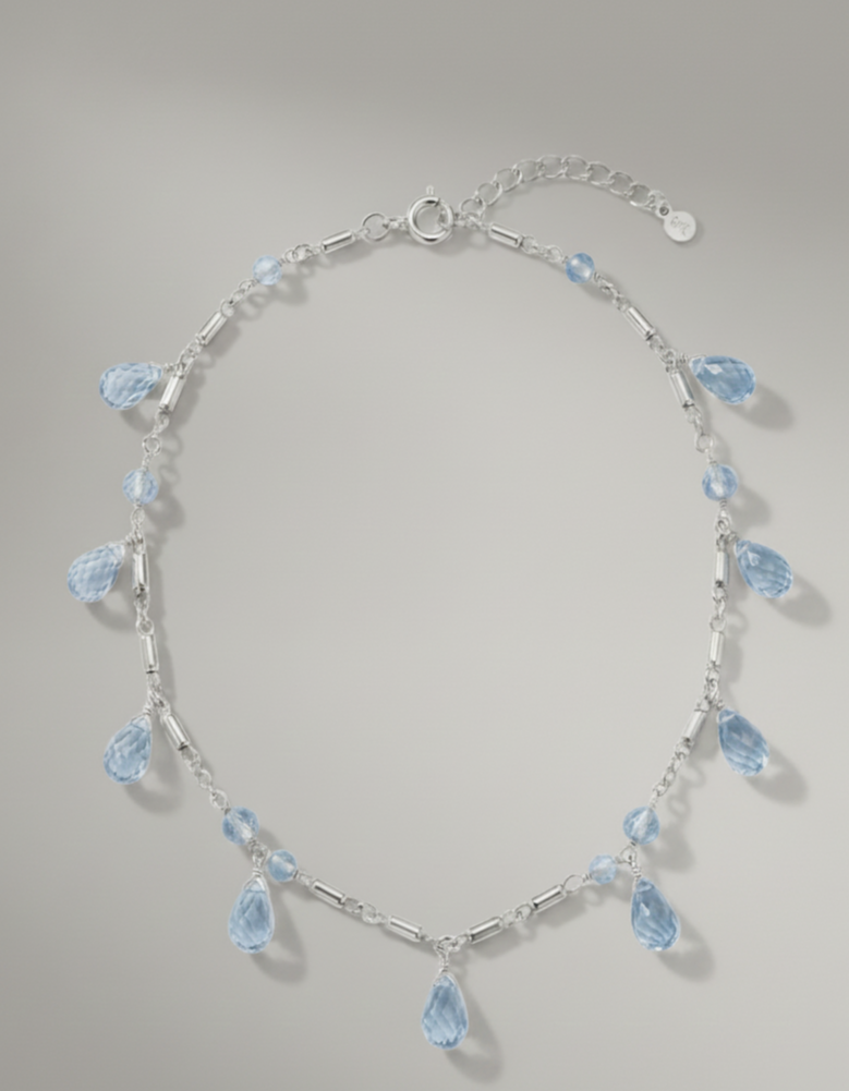A Blue topaz briolette dangle necklace in sterling silver with multiple sparkling drops of blue topaz from Brilliant Fine+Custom Jewelry