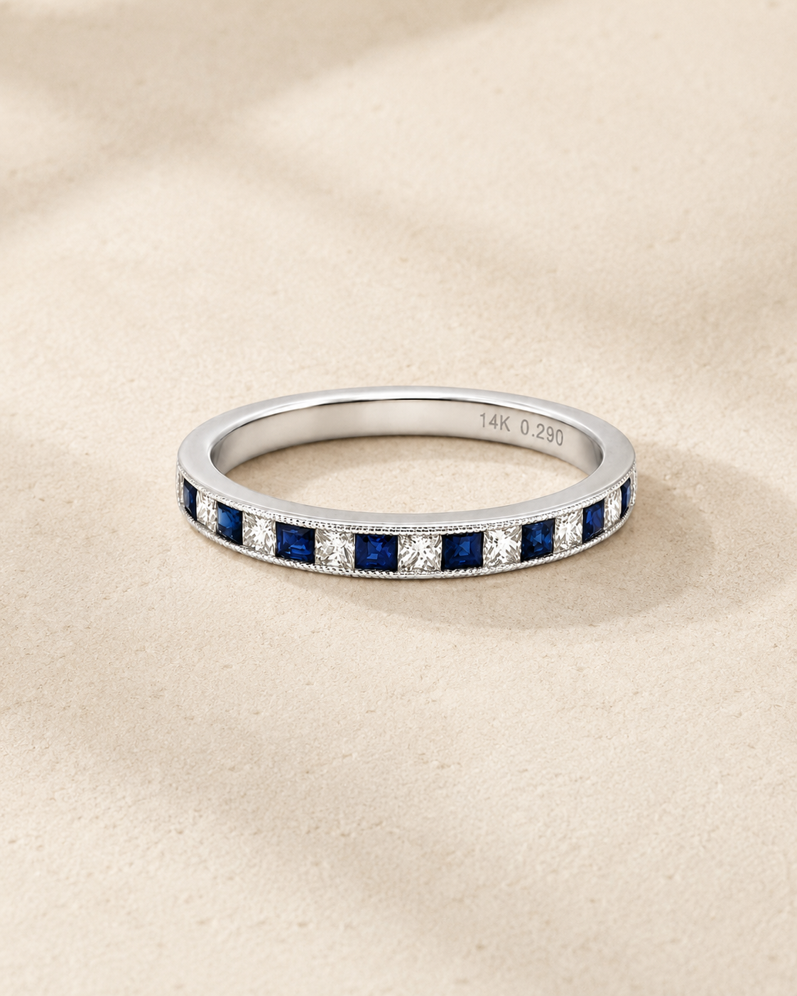 A Channel-set sapphire and diamond half band in white gold from Brilliant Fine+Custom.