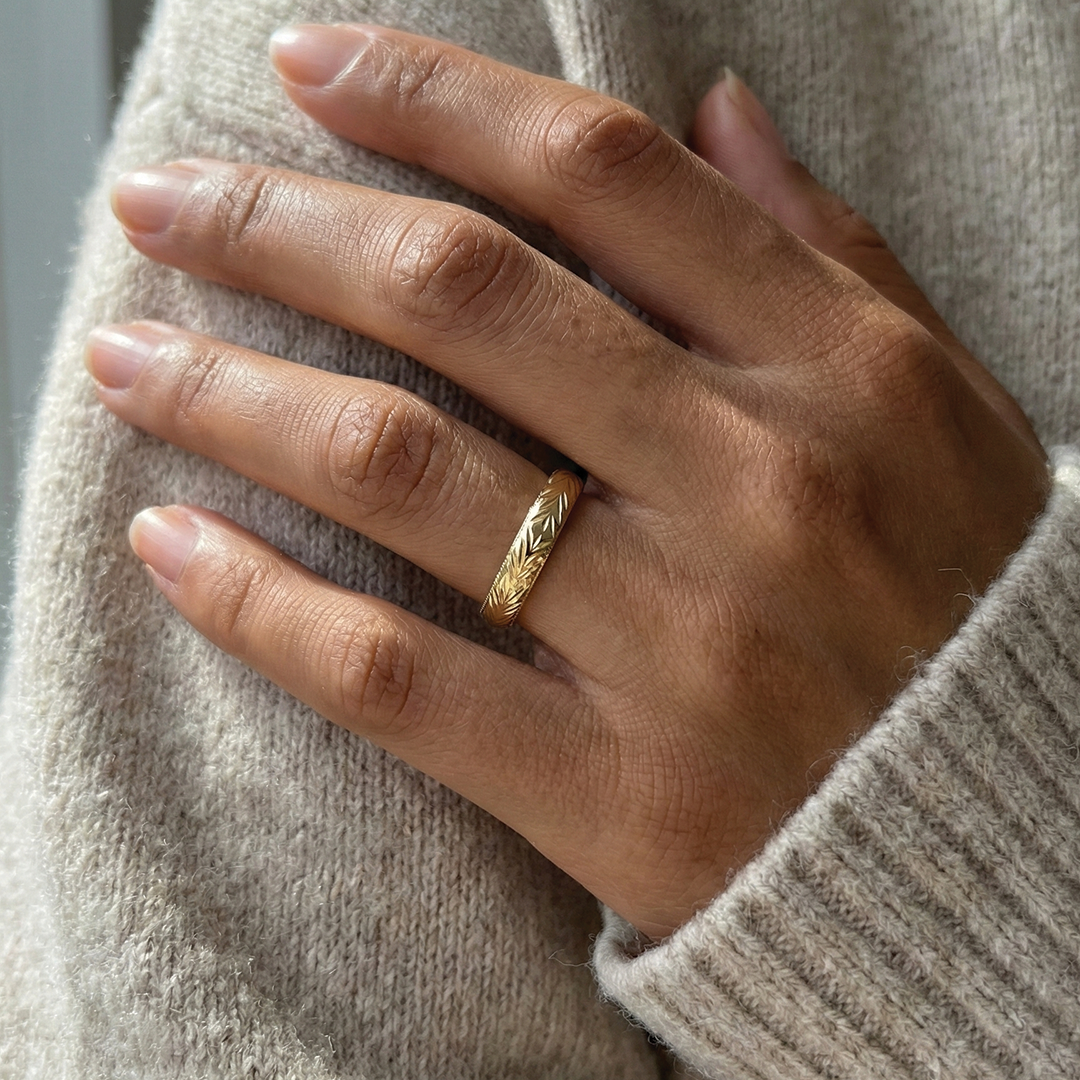 A 14k yellow gold band with personalized engraving from Brilliant Fine+Custom.