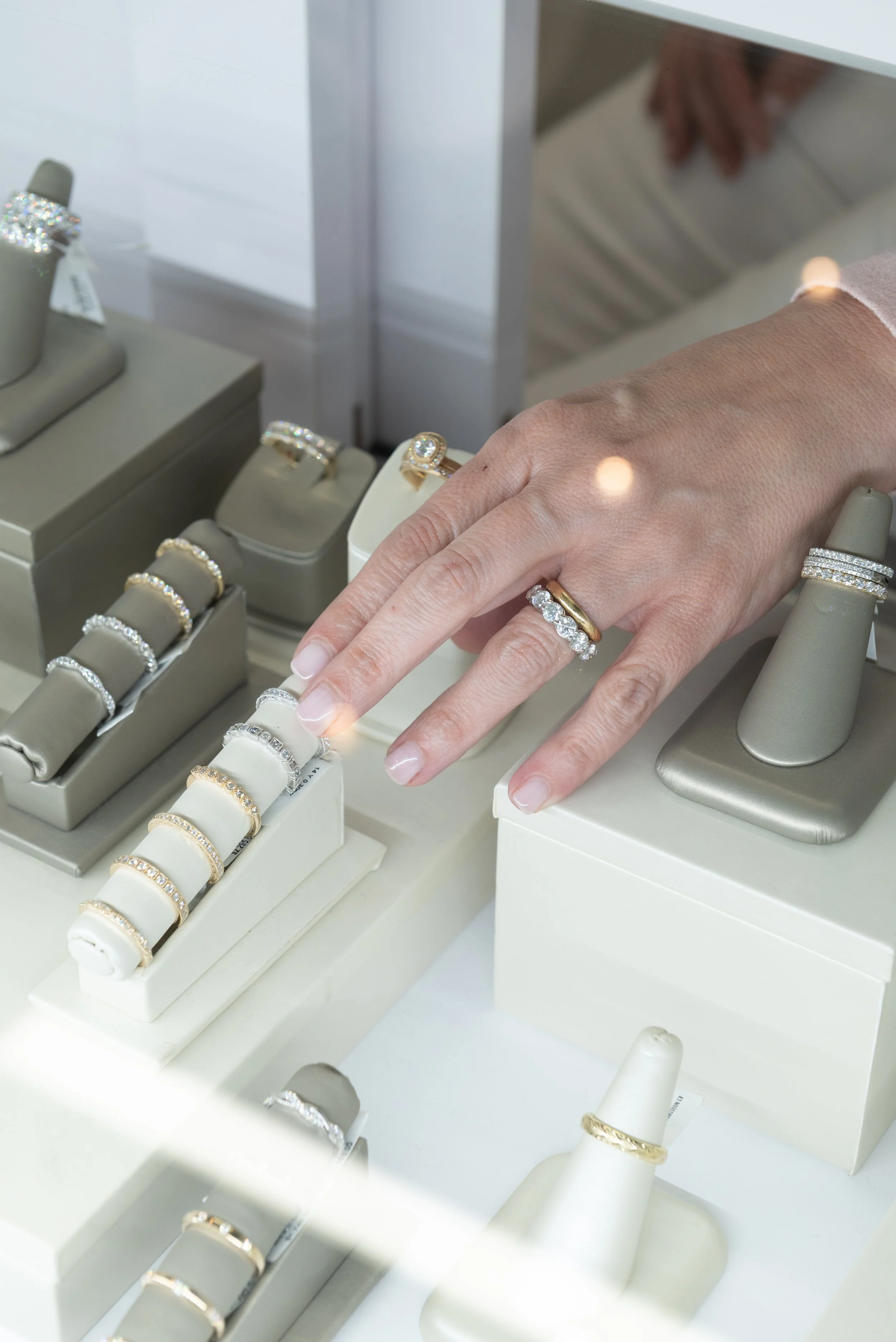 Rings on display at Brilliant Fine+Custom jewelry available in yellow and white gold with various stone settings and stone cuts available, all suitable for your unique ring stack.