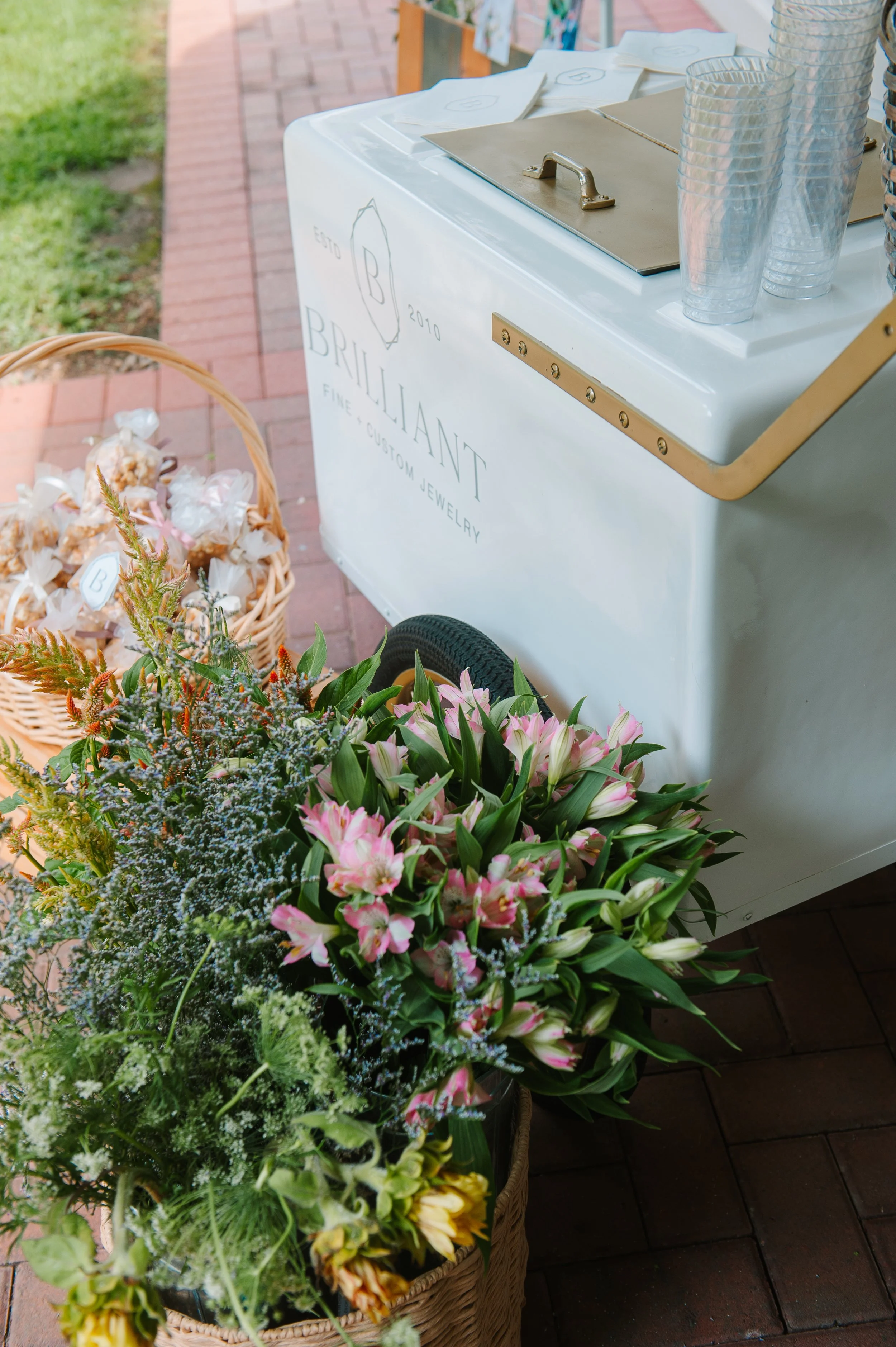 Brilliant Fine + Custom storefront in Historic Downtown Roswell decorated with flowers and event details for Stack Your Story