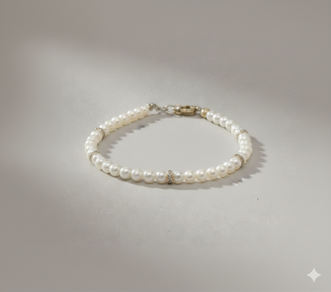 A freshwater pearl bracelet with diamond rondel stations in 14k yellow gold from Brilliant Fine+Custom Jewelry.