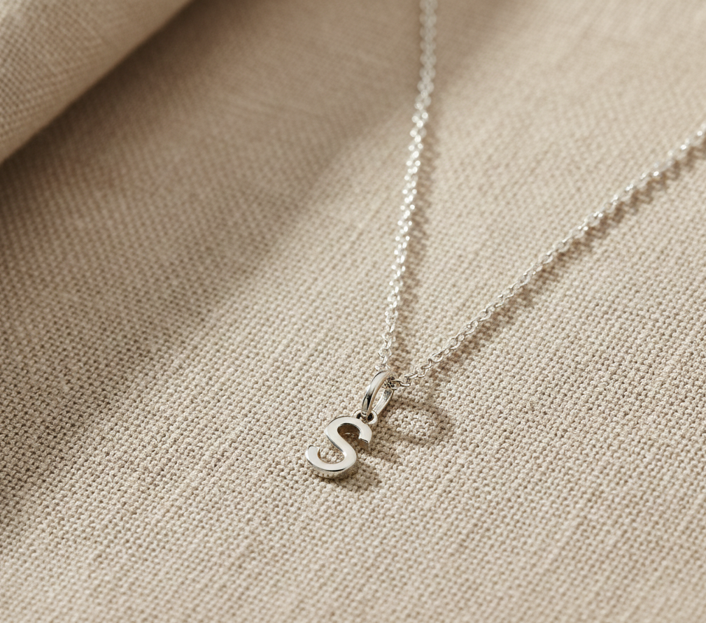 A small "S" pendant in Sterling Silver on a sterling silver cable chain for babies & kids from Brilliant Fine+Custom Jewelry.