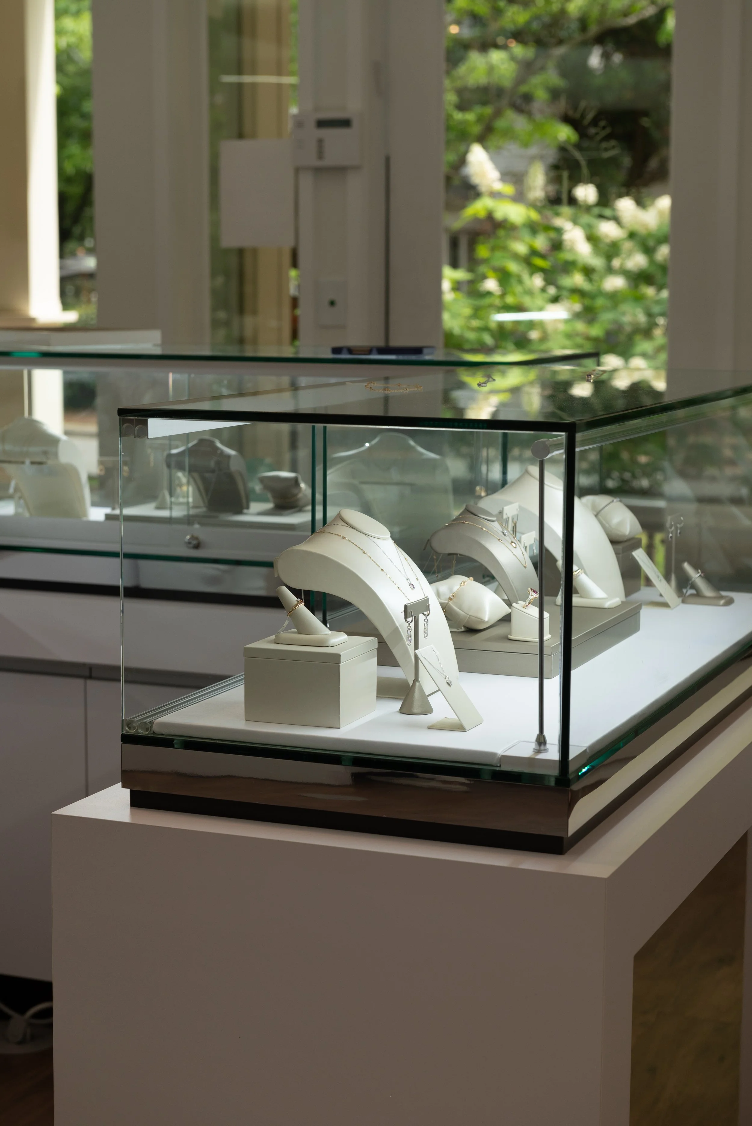 Elegant display cabinets filled with exquisite ready to wear jewelry in Brilliant Fine+Custom's showroom just north of Atlanta in Roswell, GA.