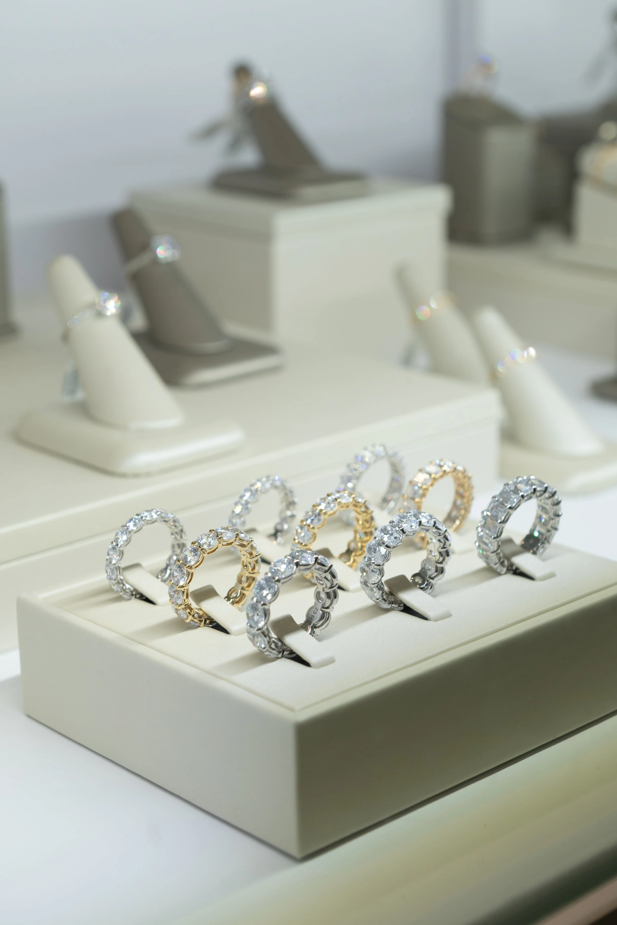 Multi-stone Diamond Bands in white gold, platinum, and yellow gold on display at Brilliant Fine+Custom. A perfect compliment to your Ring Stack.