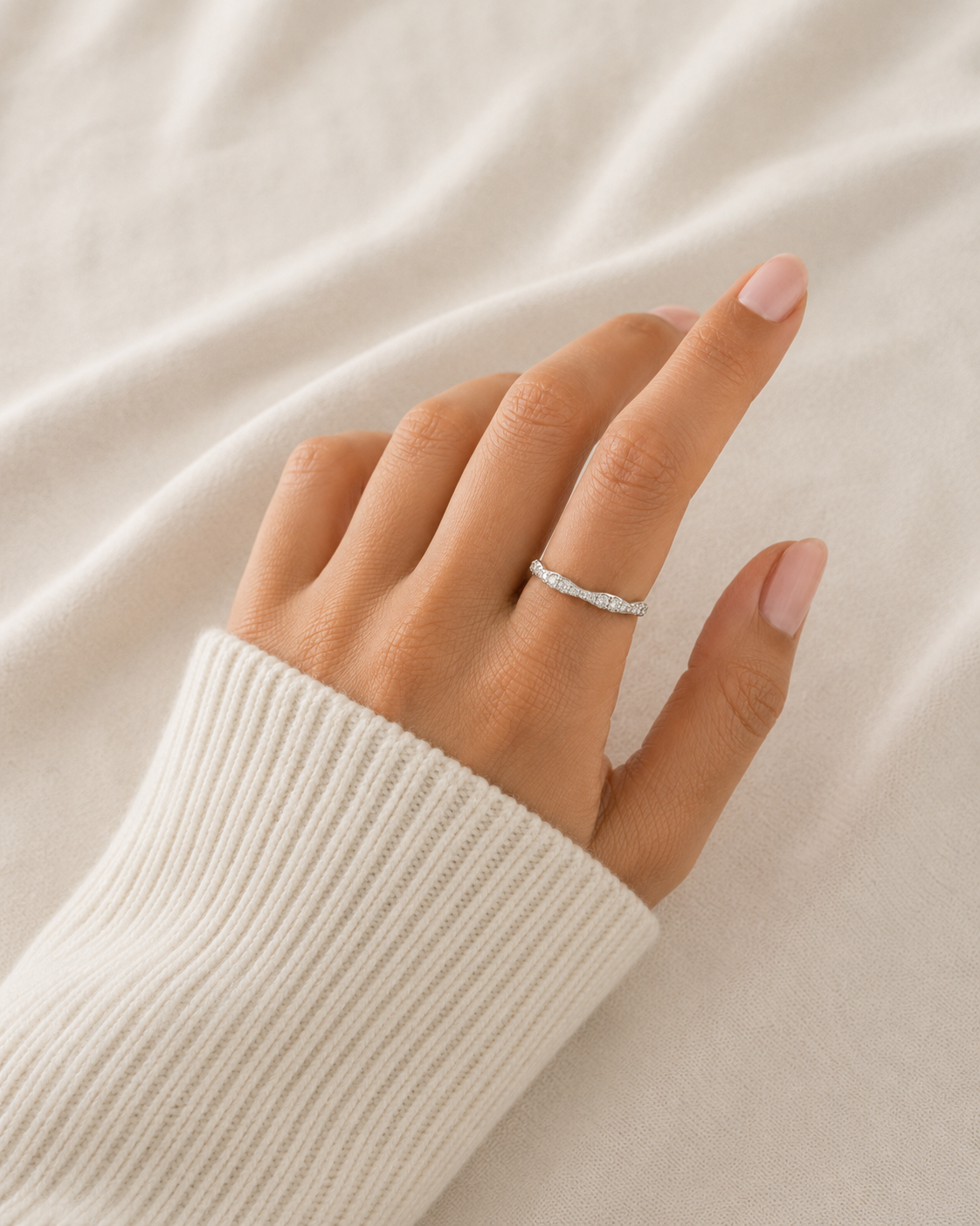 A wave-diamond half-band ring in white gold from Brilliant Fine+Custom Jewelry.