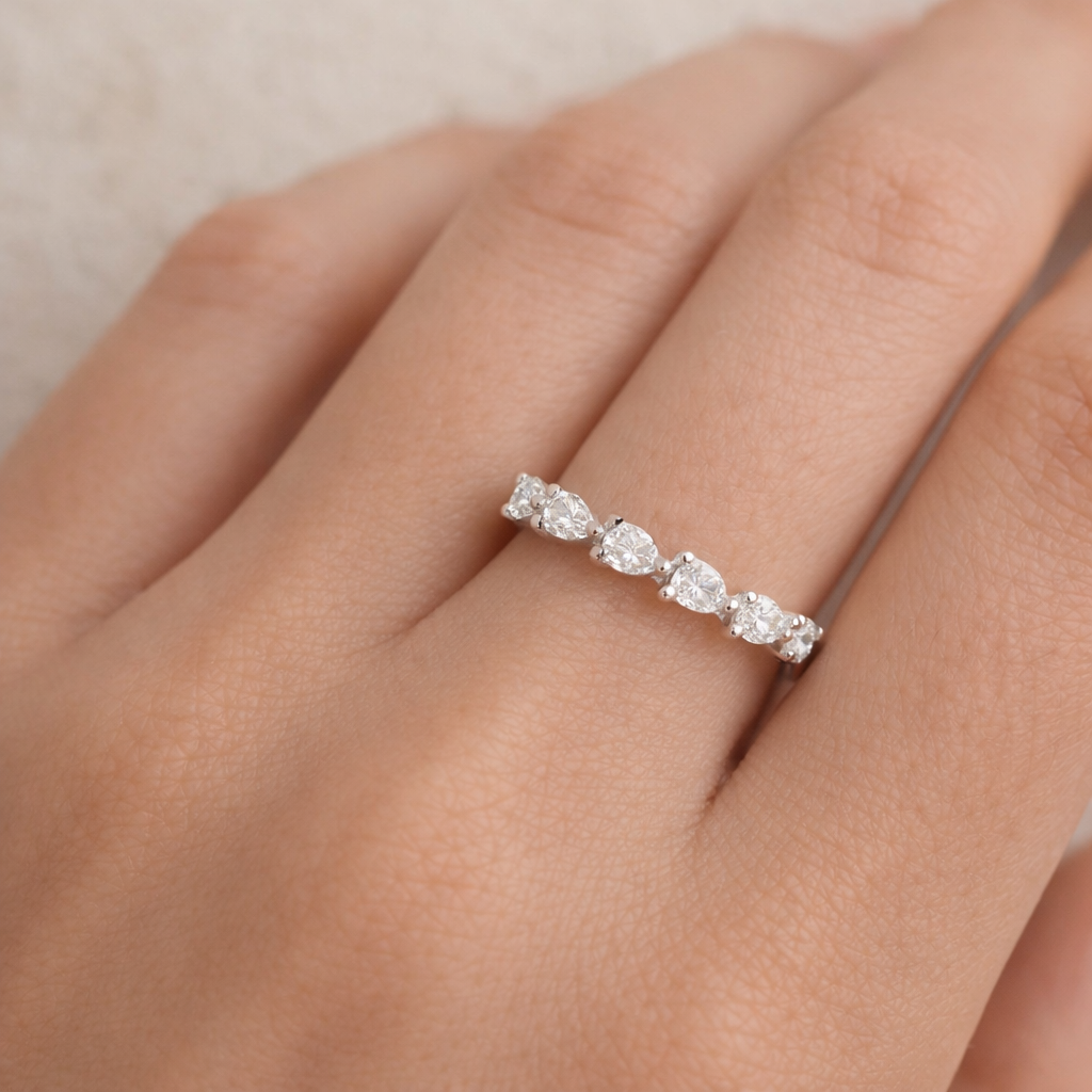 An elegant 14k white gold band featuring 7 Pear-shaped diamond stones arranged halfway around the top of the band, bringing softness and sparkle to your ring stack. Lovingly crafted by Brilliant Fine+Custom Jewelry.