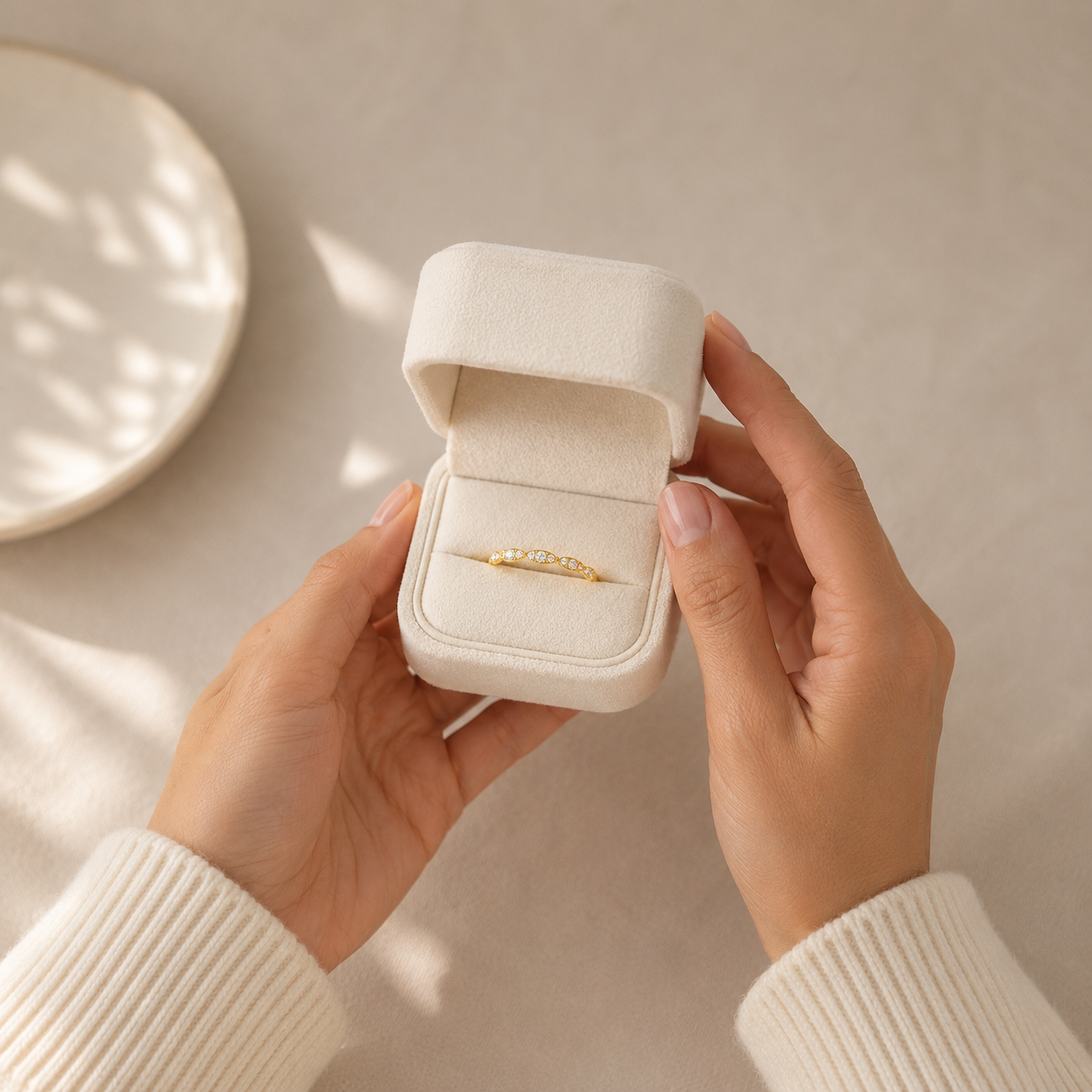 A Round-Stone Diamond Half-Band in yellow gold in a velvet ring box from Brilliant Fine+Custom Jewelry.