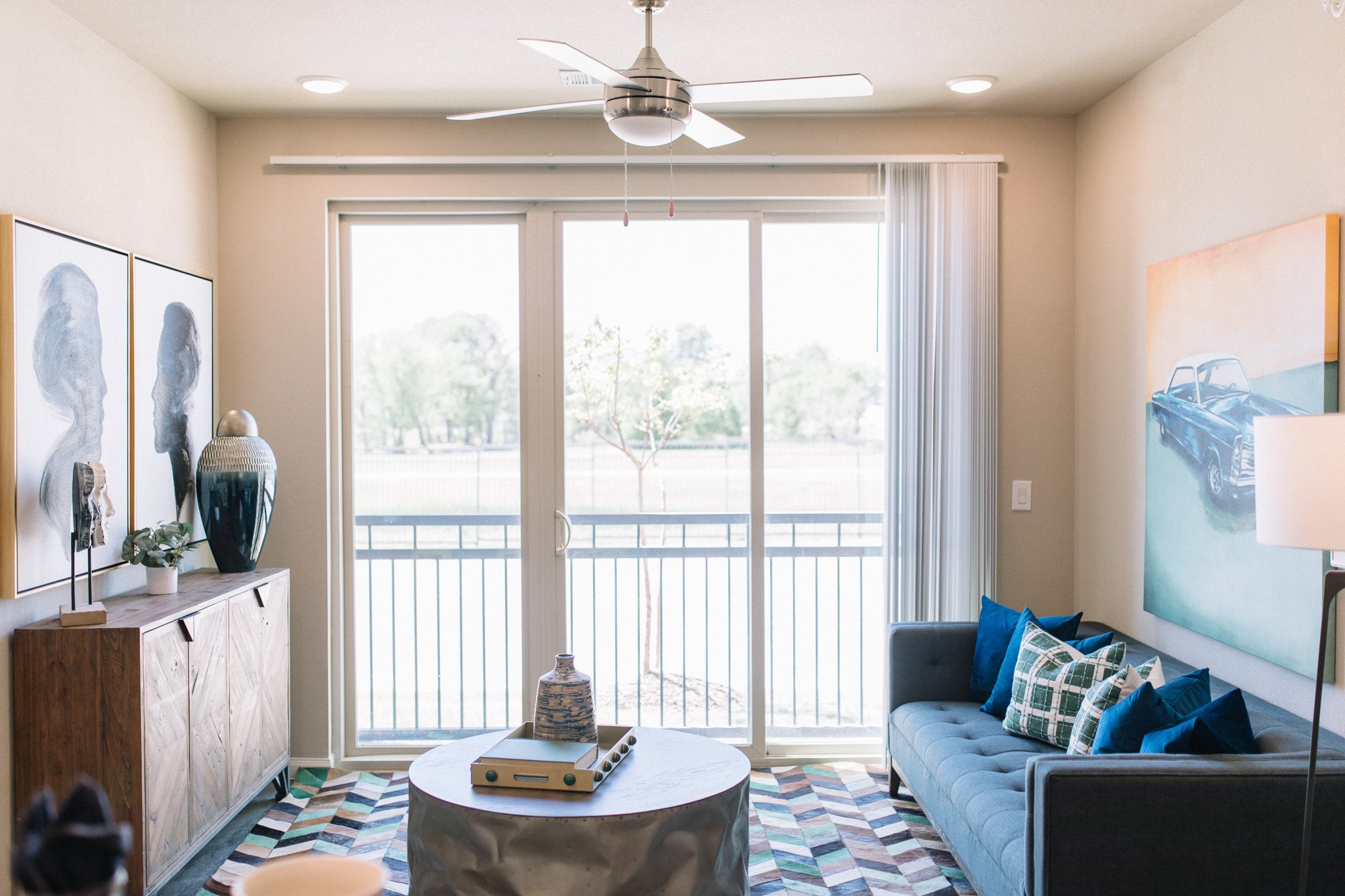 Living room with a blue couch and a circular metal coffee table