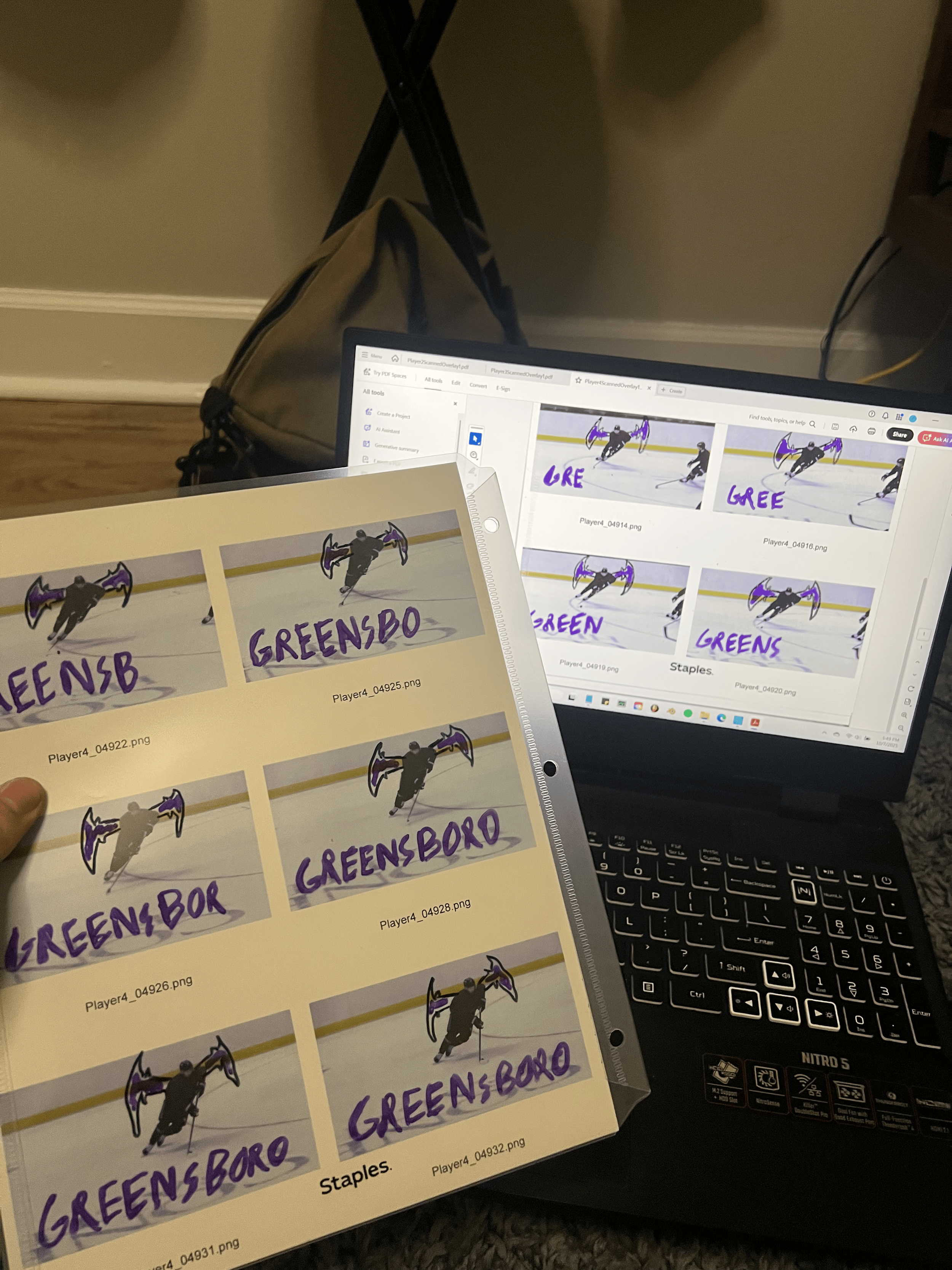 Printed pictures of a hockey player with the word 'GREENSBORO' written on them, and a computer screen displaying the same images with the same word.
