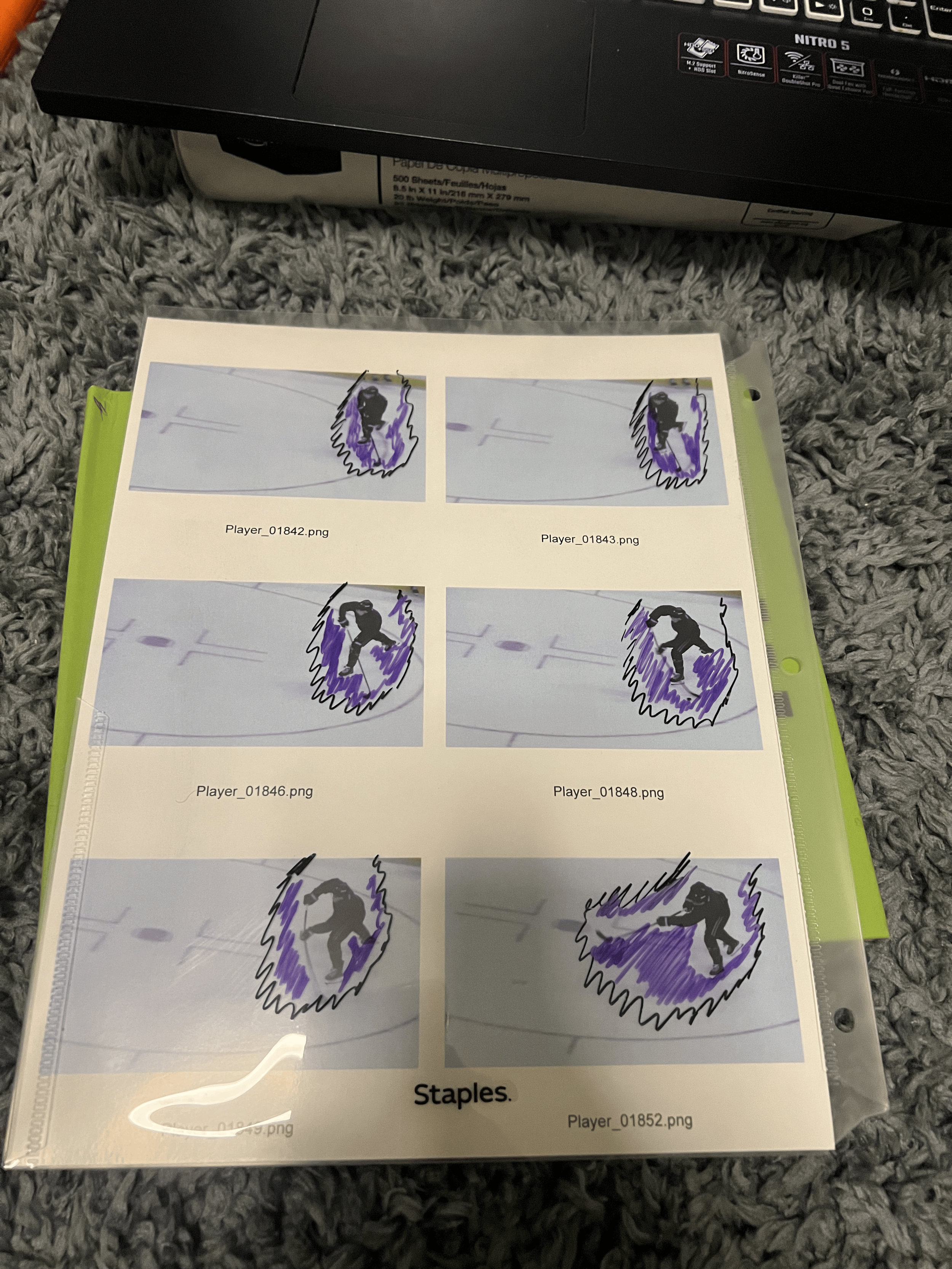 A sheet of paper with six printed images of a skateboarder riding a purple and black skateboard on a skatepark surface, with some images enhanced with black doodles of the skateboarder.
