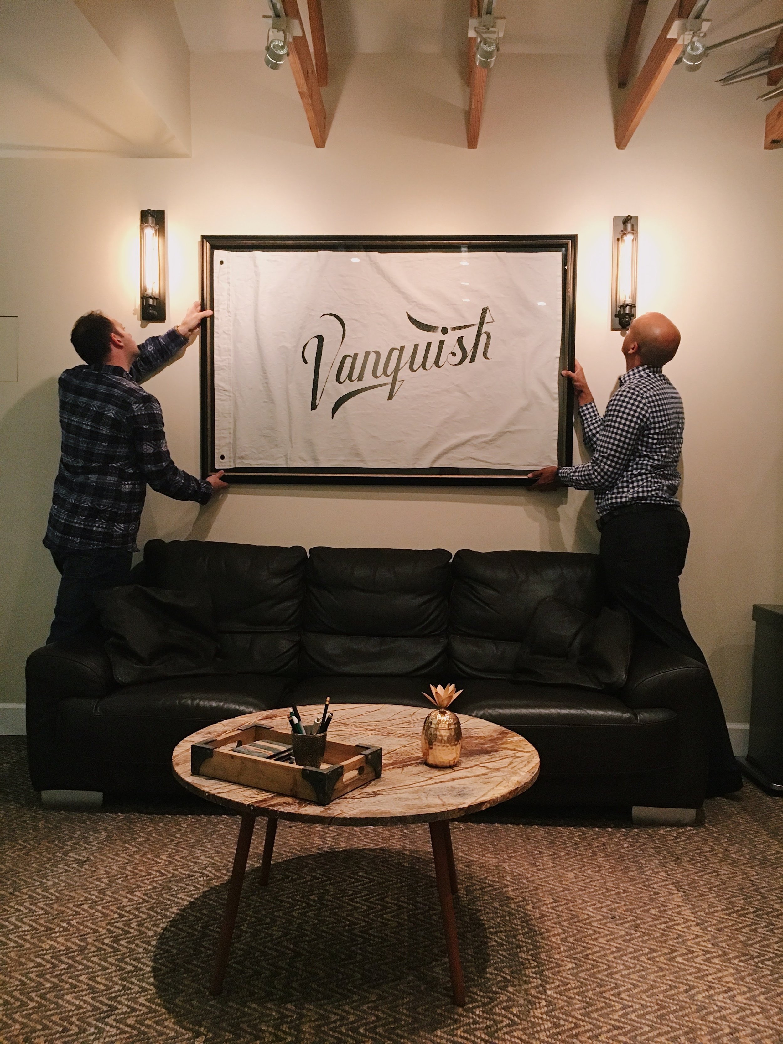 Joseph Salamida and Shaun Hixon hanging the custom Vanquish Studios Wild Standard flag. Teamwork makes the dream work. 