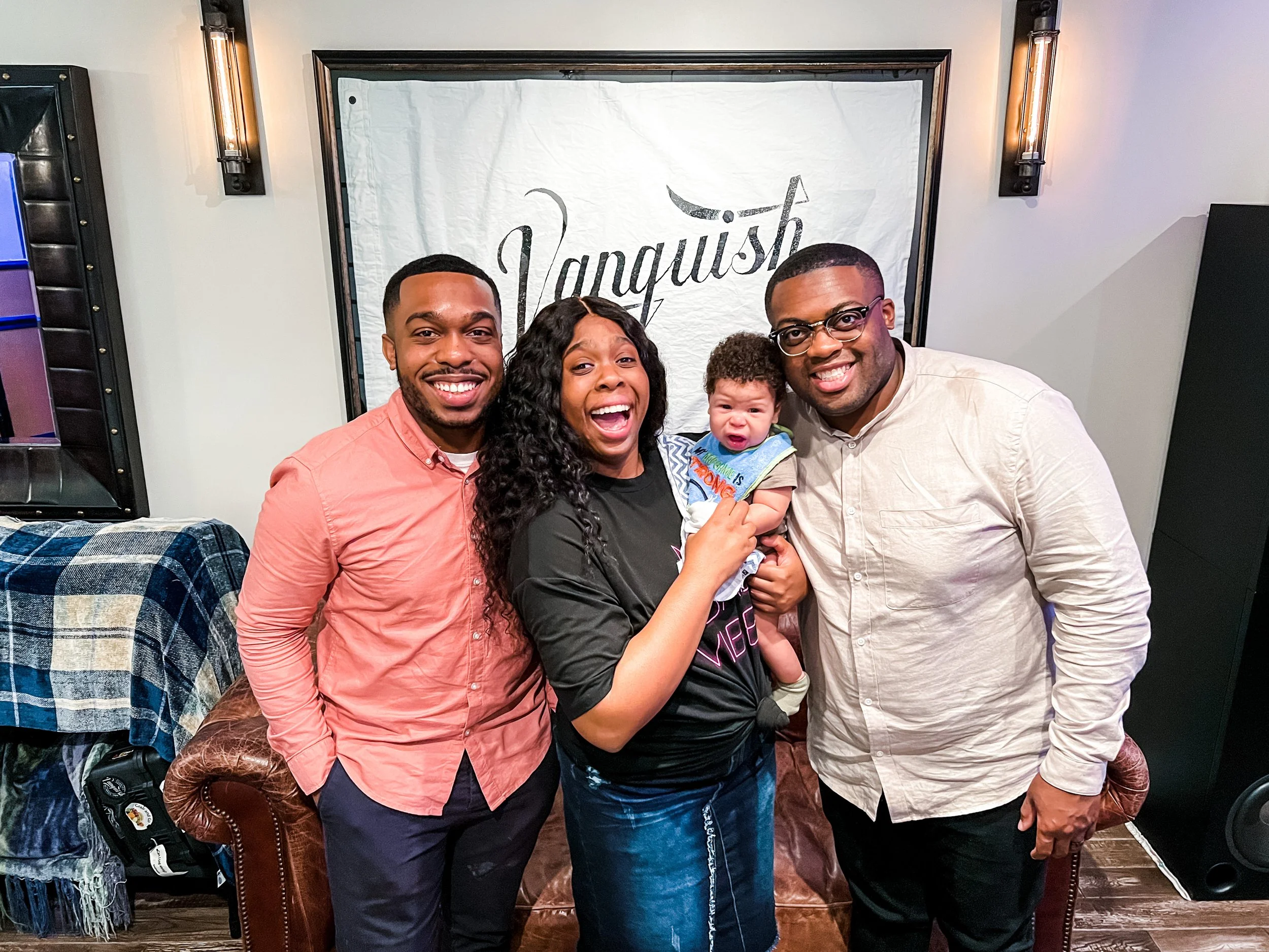 Xavier Campbell, Jeremy and Samone Doiley, with their newest addition working at Vanquish Studios. 