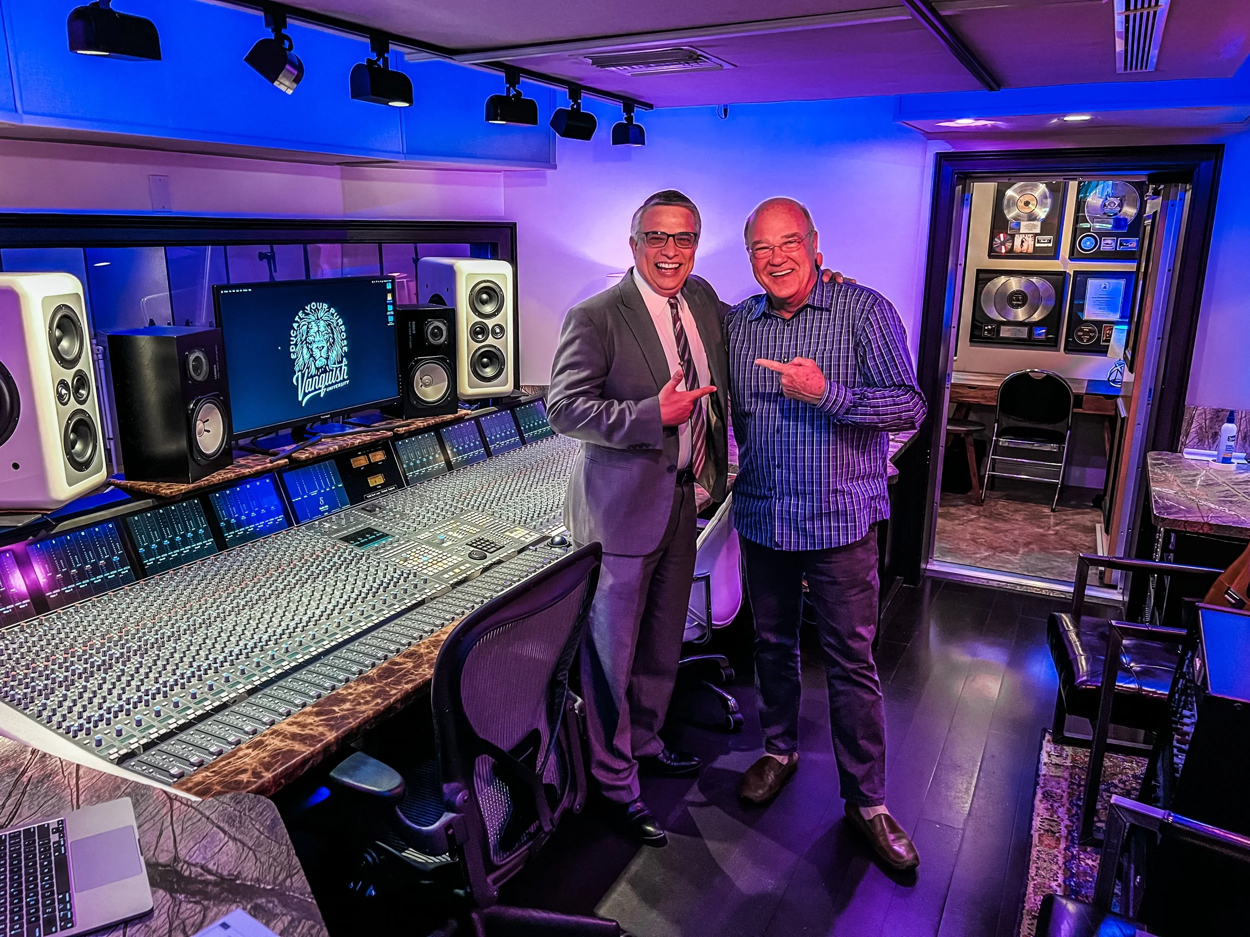 Pastor Mark Hattabough and Galen Walters visiting Vanquish Studios posing in front of the Solid State Logic Duality, Yamaha NS-10's, and Barefoot Sound MM26 Monitors. 