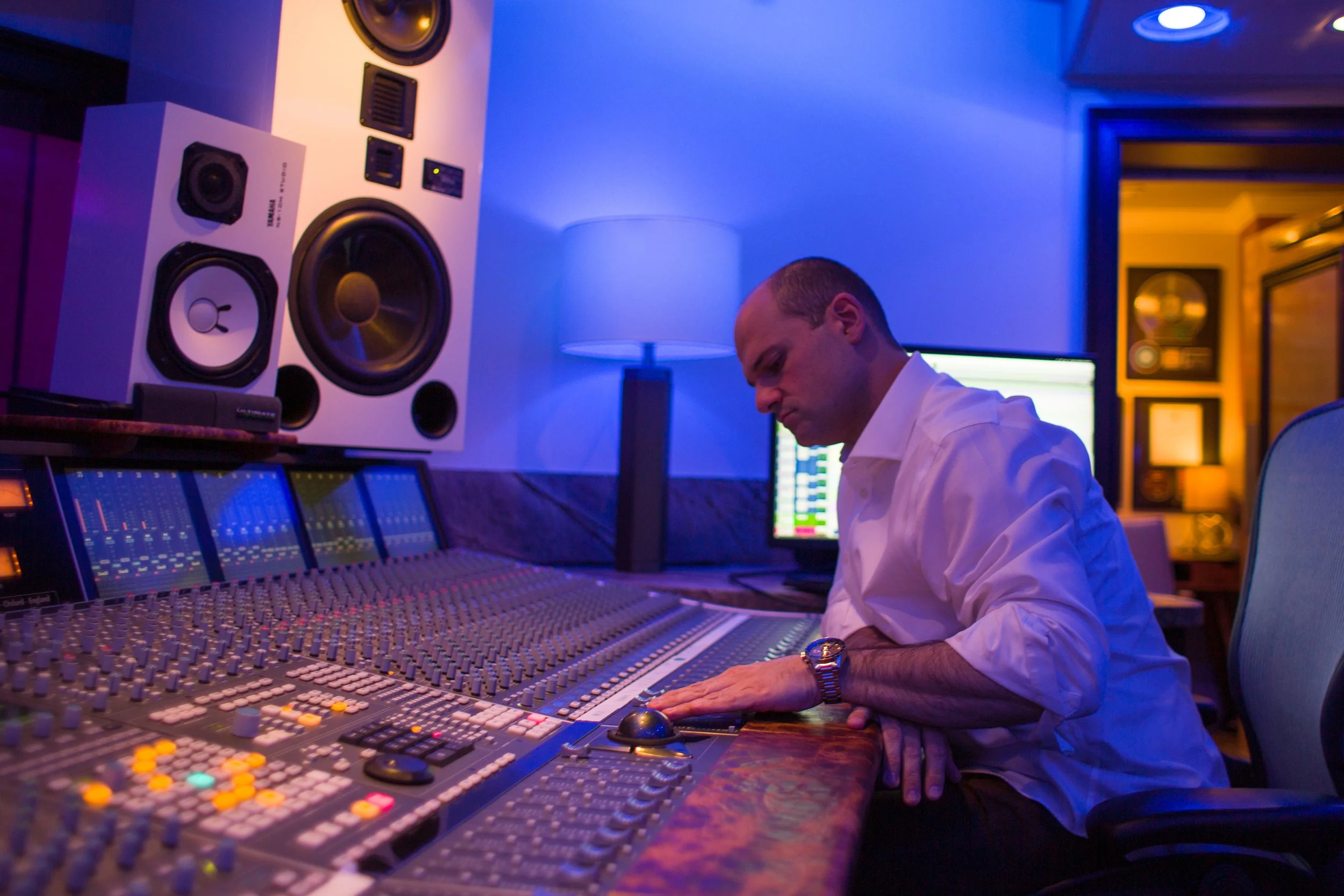 Owner and founder of Vanquish Studios engineering on the 48 Channel Solid State Logic Duality. Pictured here are the custom wrapped Adam S5VA and Yamaha NS-10 Monitors. 