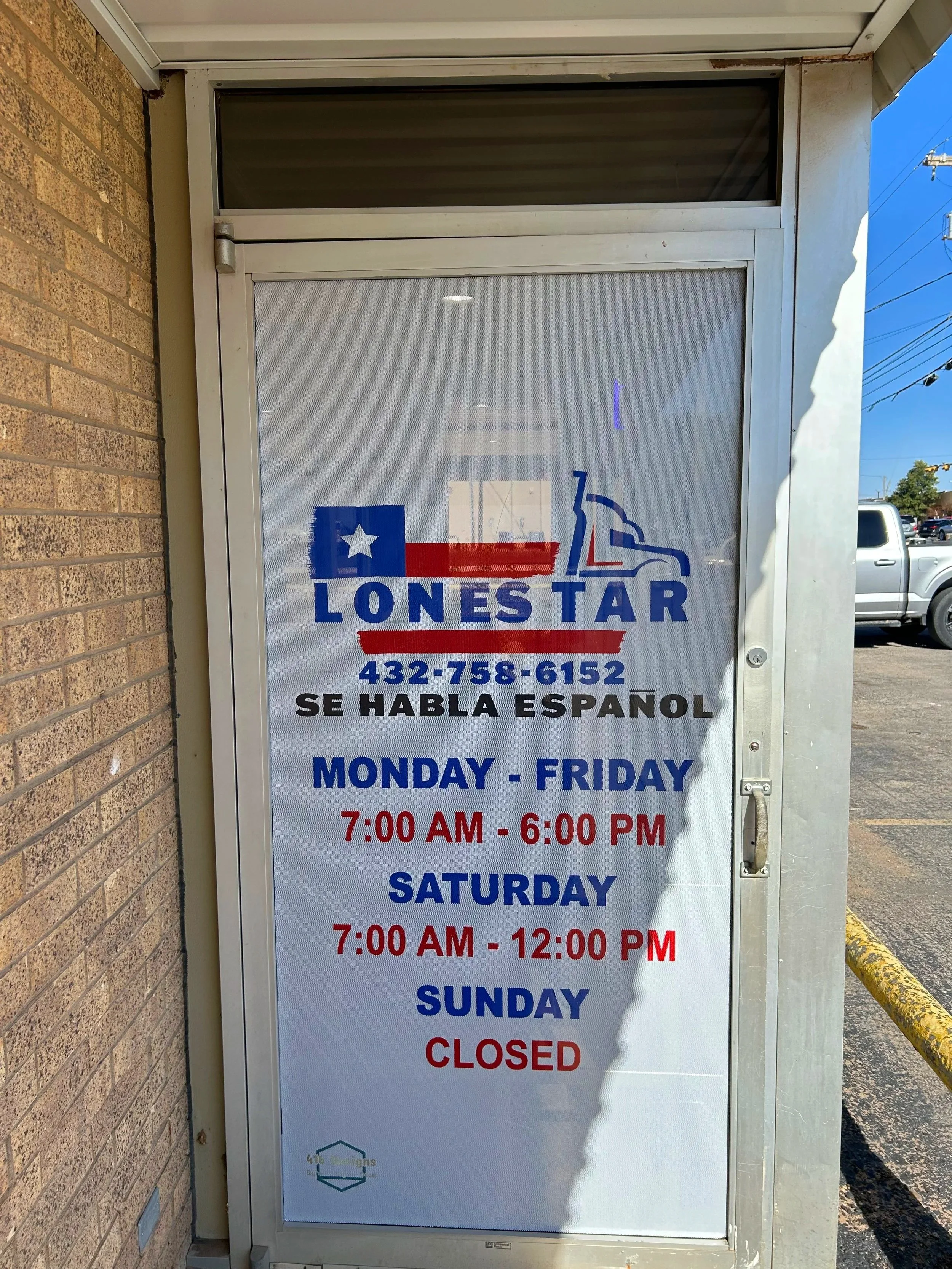 Sign on a glass door with store hours and information in English and Spanish, and a logo at the bottom. The hours for Monday to Friday are 7:00 AM to 6:00 PM, Saturday from 7:00 AM to 12:00 PM, and the store is closed on Sunday.