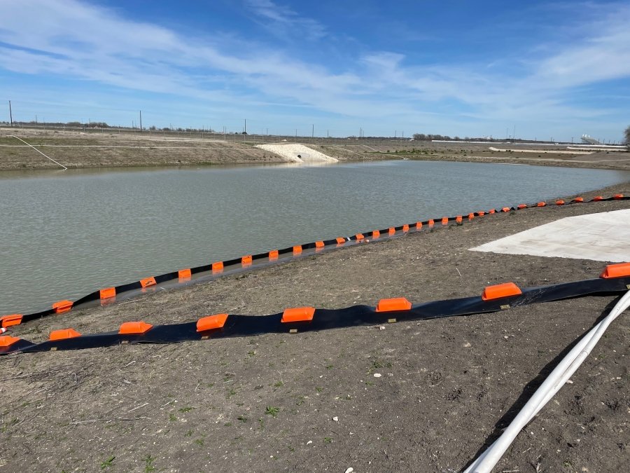 Construction site with water retention pond and erosion control silt fence