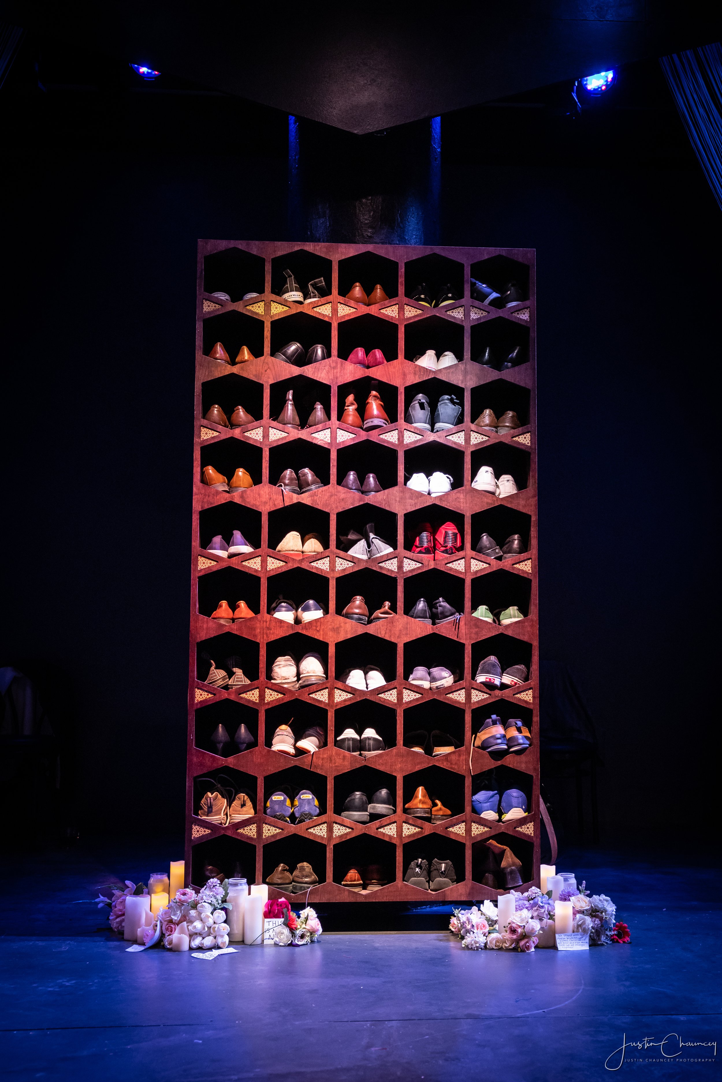 Shoe cubby inspired by those found in mosques creating the memorial at the center of the set.
