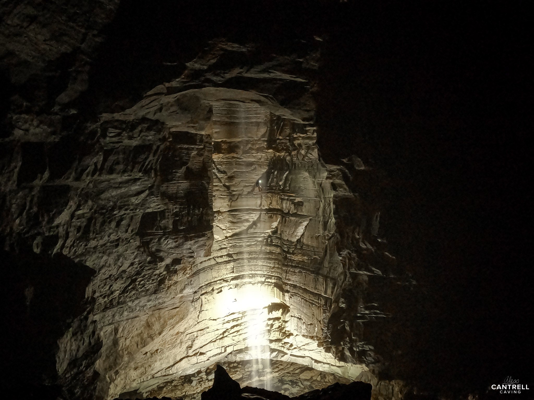 Dimly lit cave interior with textured rock formations.