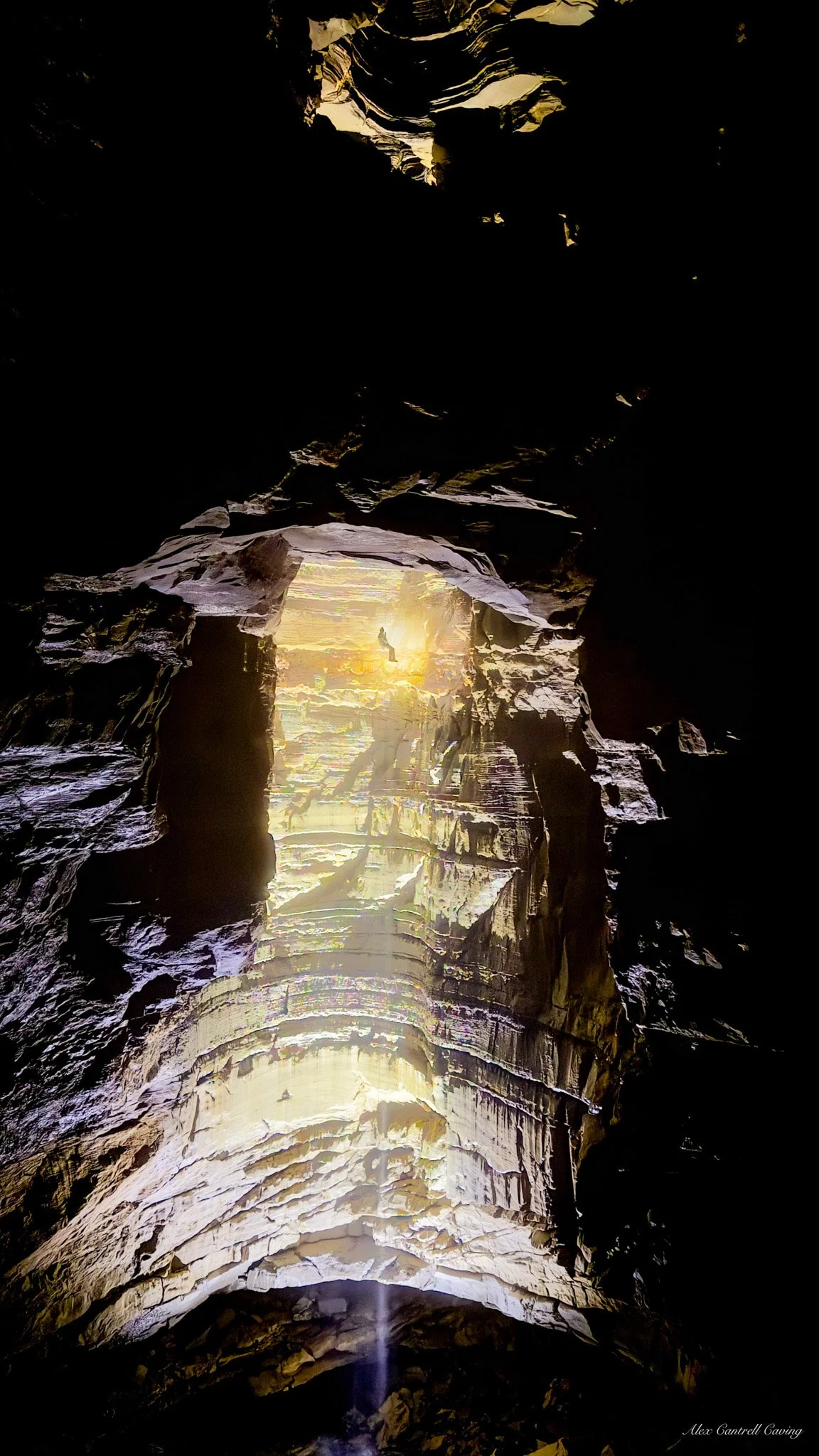 Sunlit cave opening with rock formations