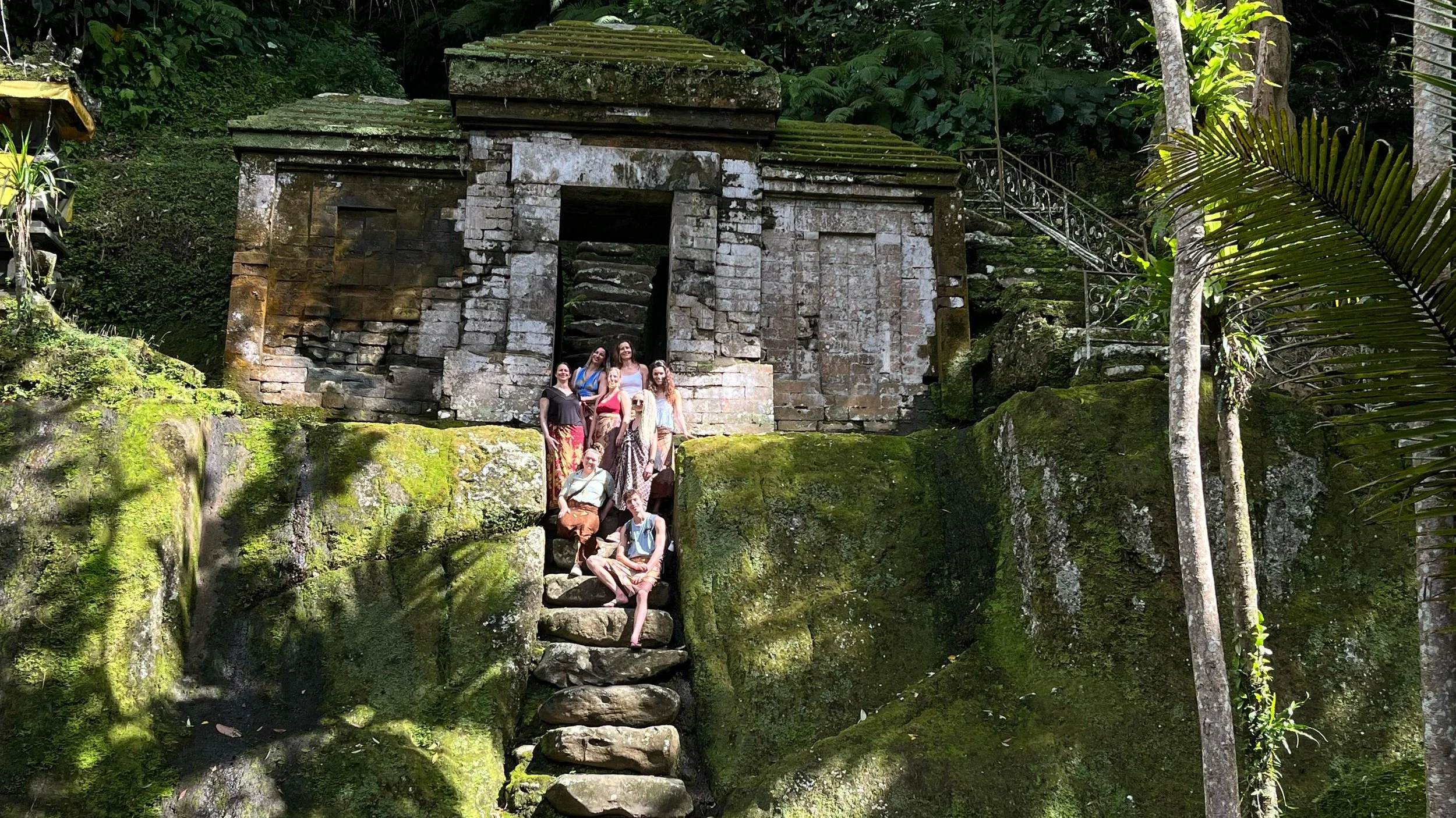 Yoga Teacher Training students participating in a cultural visit to a sacred Balinese temple as part of their immersion in Bali’s spiritual traditions