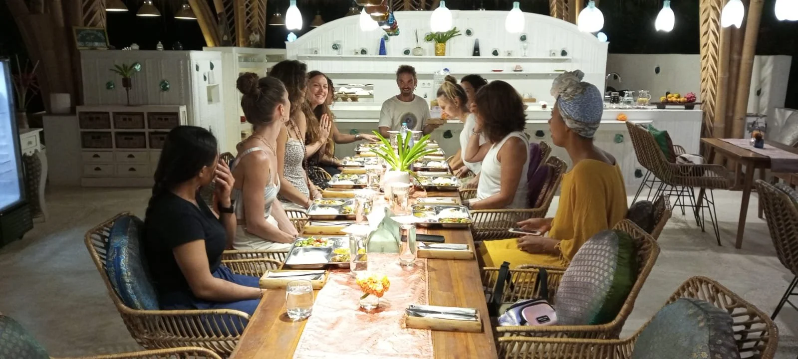 Yoga Teacher Training students sharing a plant-based meal together in the SKY eco-village community space in Bali