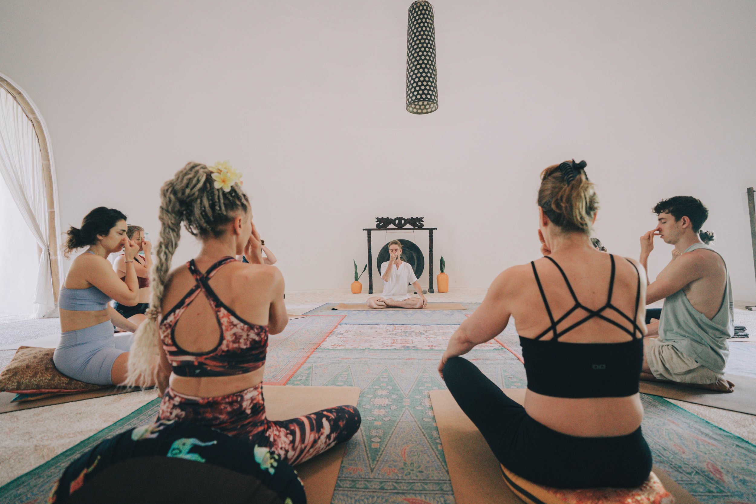 200-hour Yoga Teacher Training students practicing Kapalbhati Pranayama together in a seated circle, a cleansing breathwork technique used in Shuddhi Kriyas