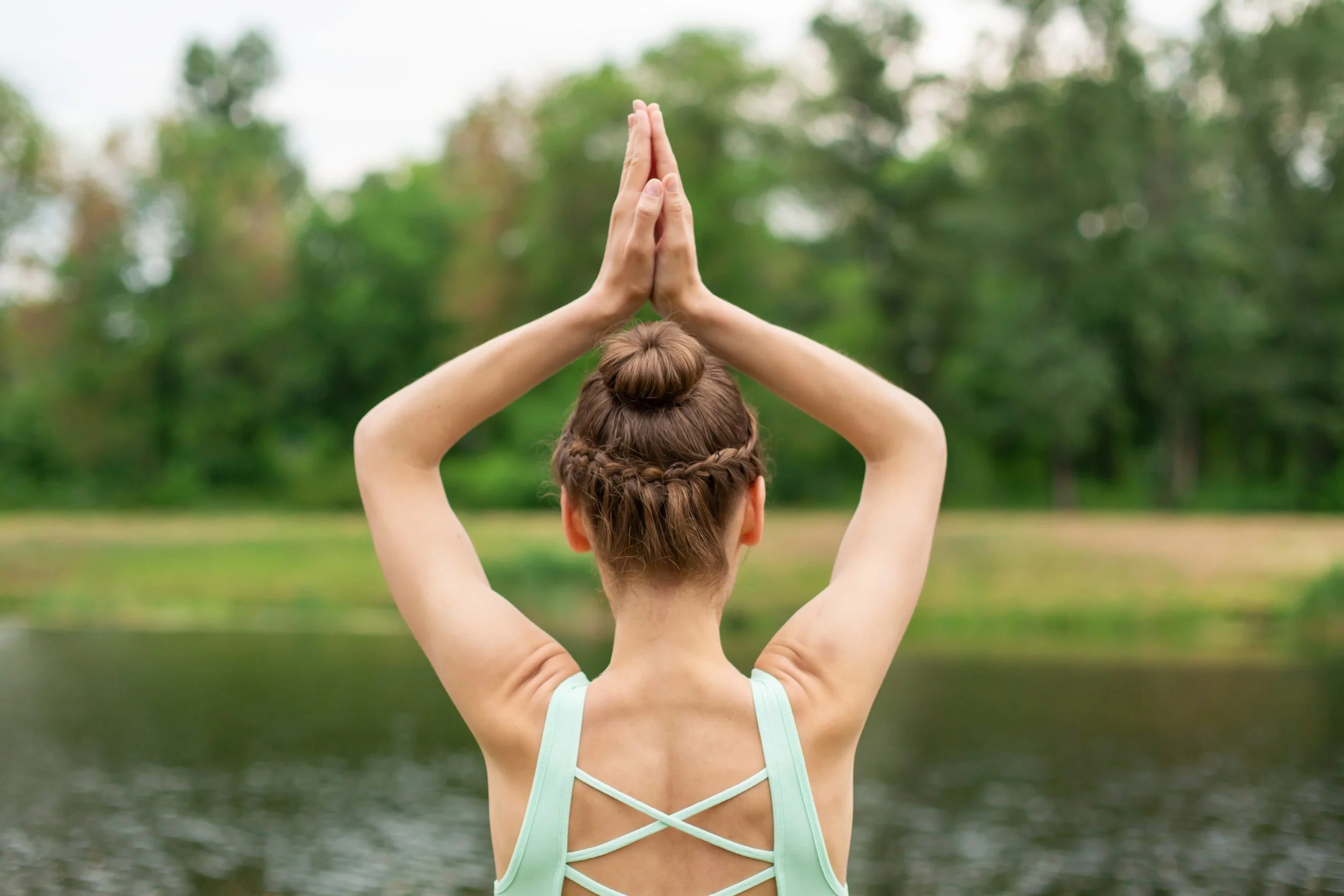 Yoga practitioner in Bali performing mindful pose overlooking the jungle, reflecting the yamas and harmony taught at SKY Yoga and Meditation