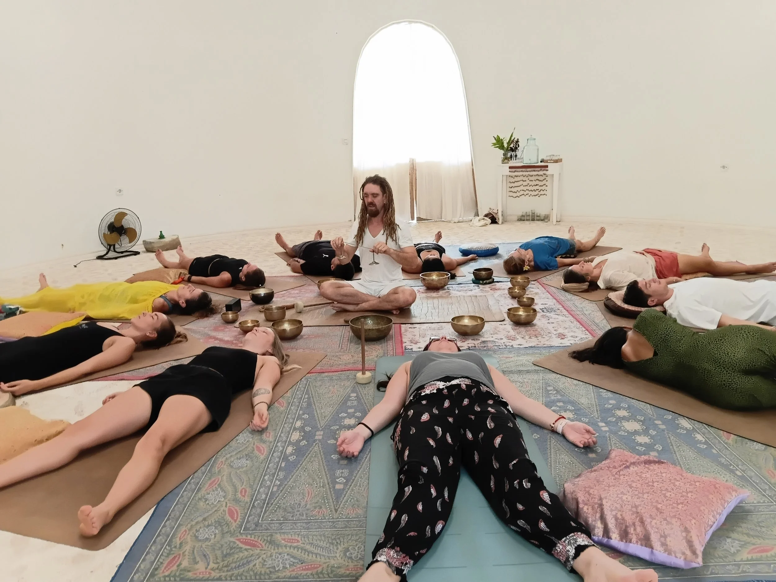 Group sound healing session with Tibetan bowls inside SKY’s sound dome, supporting deep relaxation and energetic balance during Yoga Teacher Training