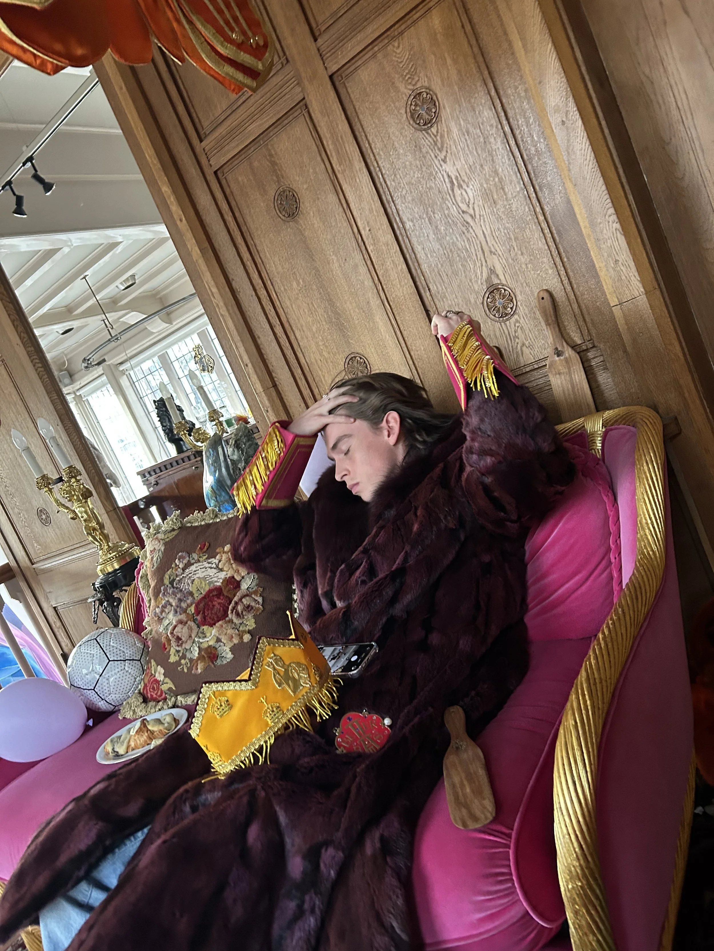 Person wearing BETTER BÅLLS in the Amsterdam showroom surrounded by antiques, art and everyday objects