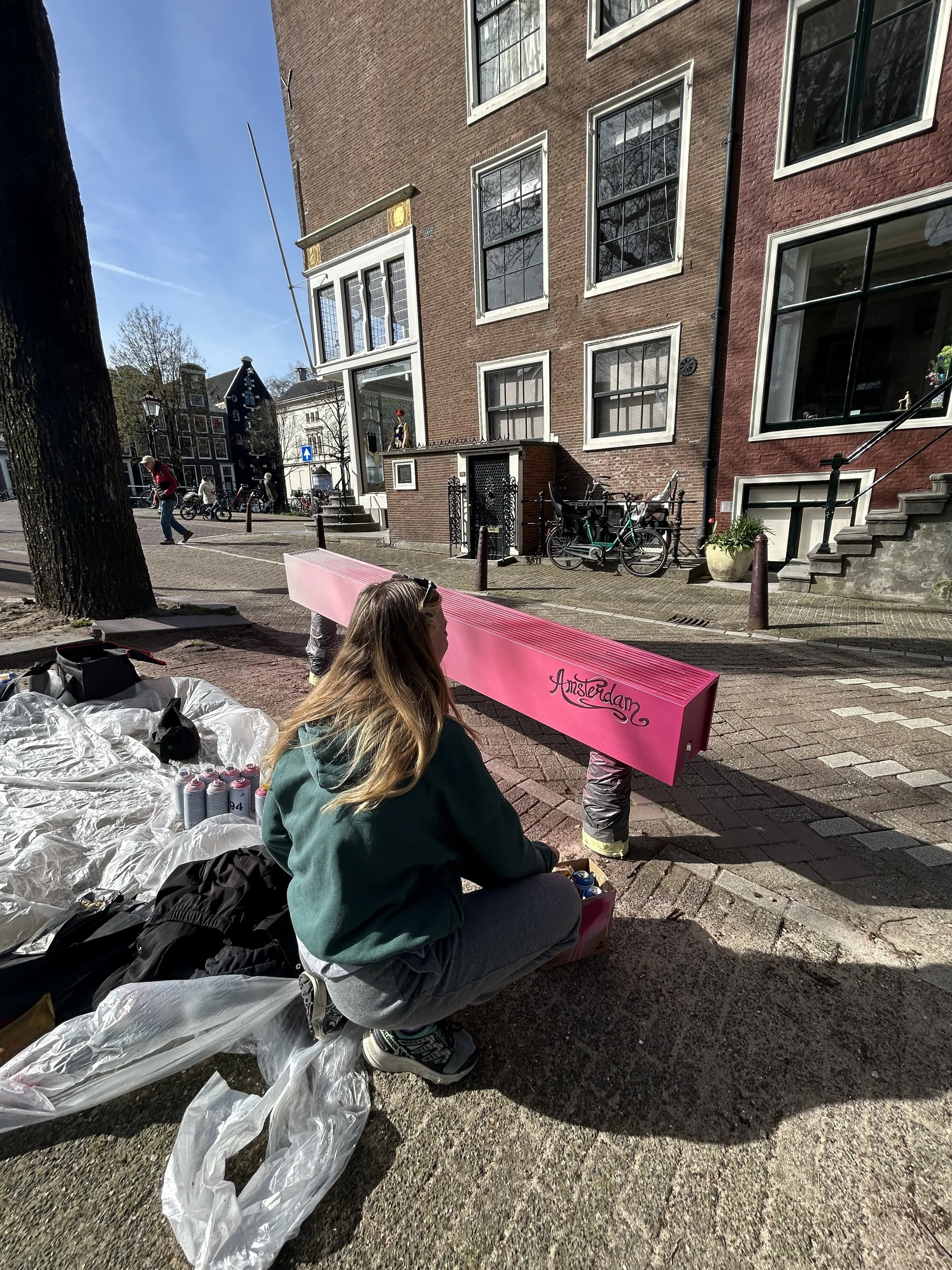 Amsterdam Female Street Artist Sames painting on the canals of Amsterdam Keizersgracht