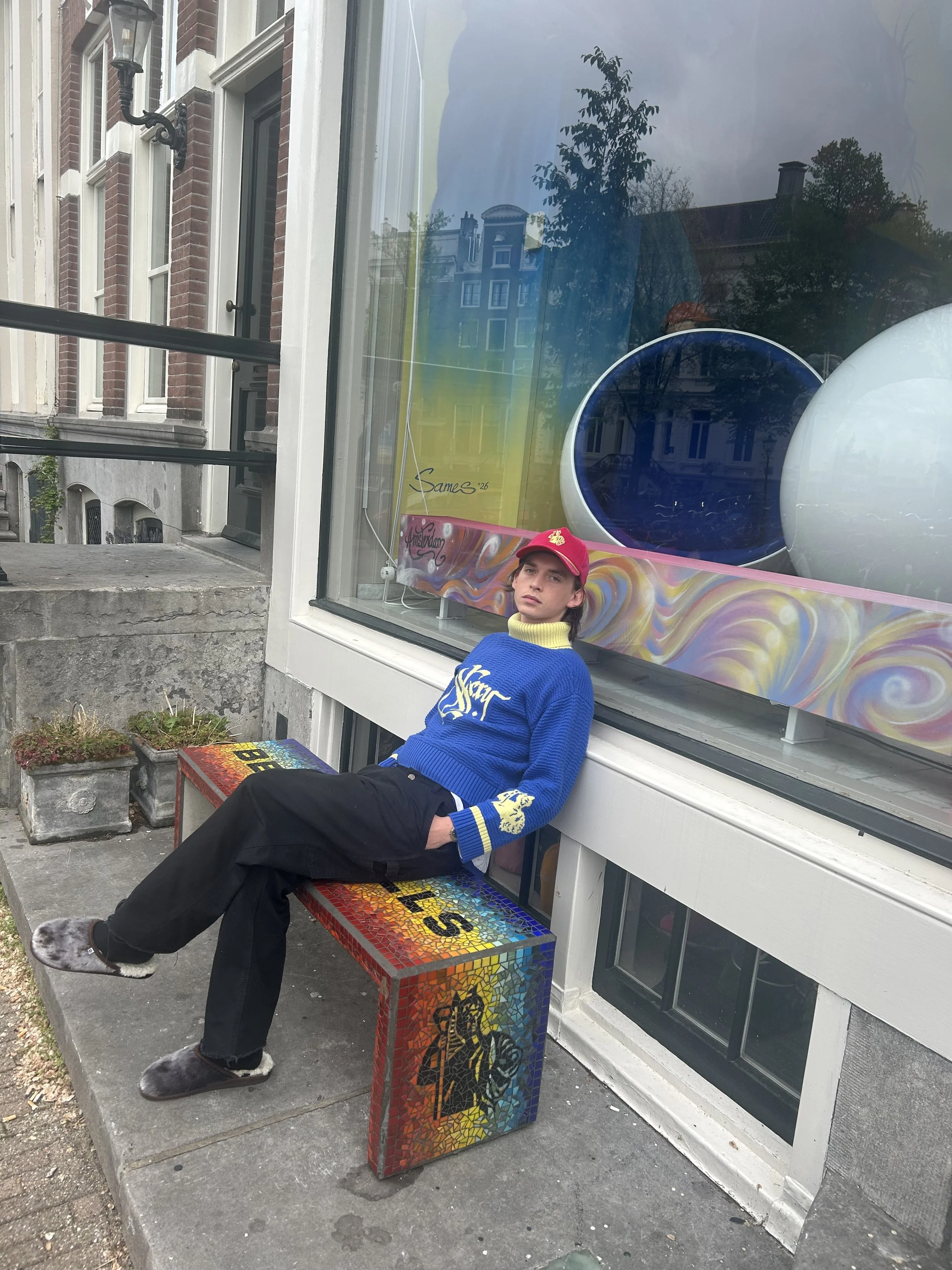 Person wearing BETTER BÅLLS knitwear outside the Amsterdam showroom at Keizersgracht 419